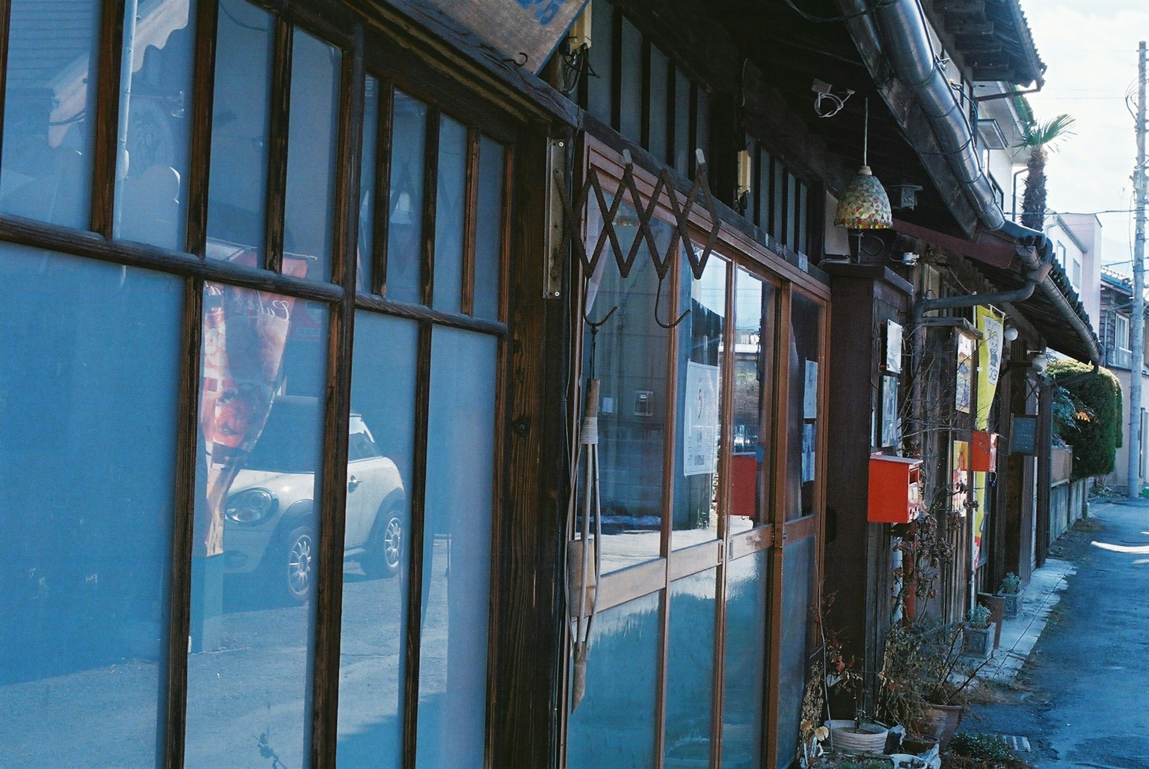 Street view featuring traditional wooden buildings and blue glass windows