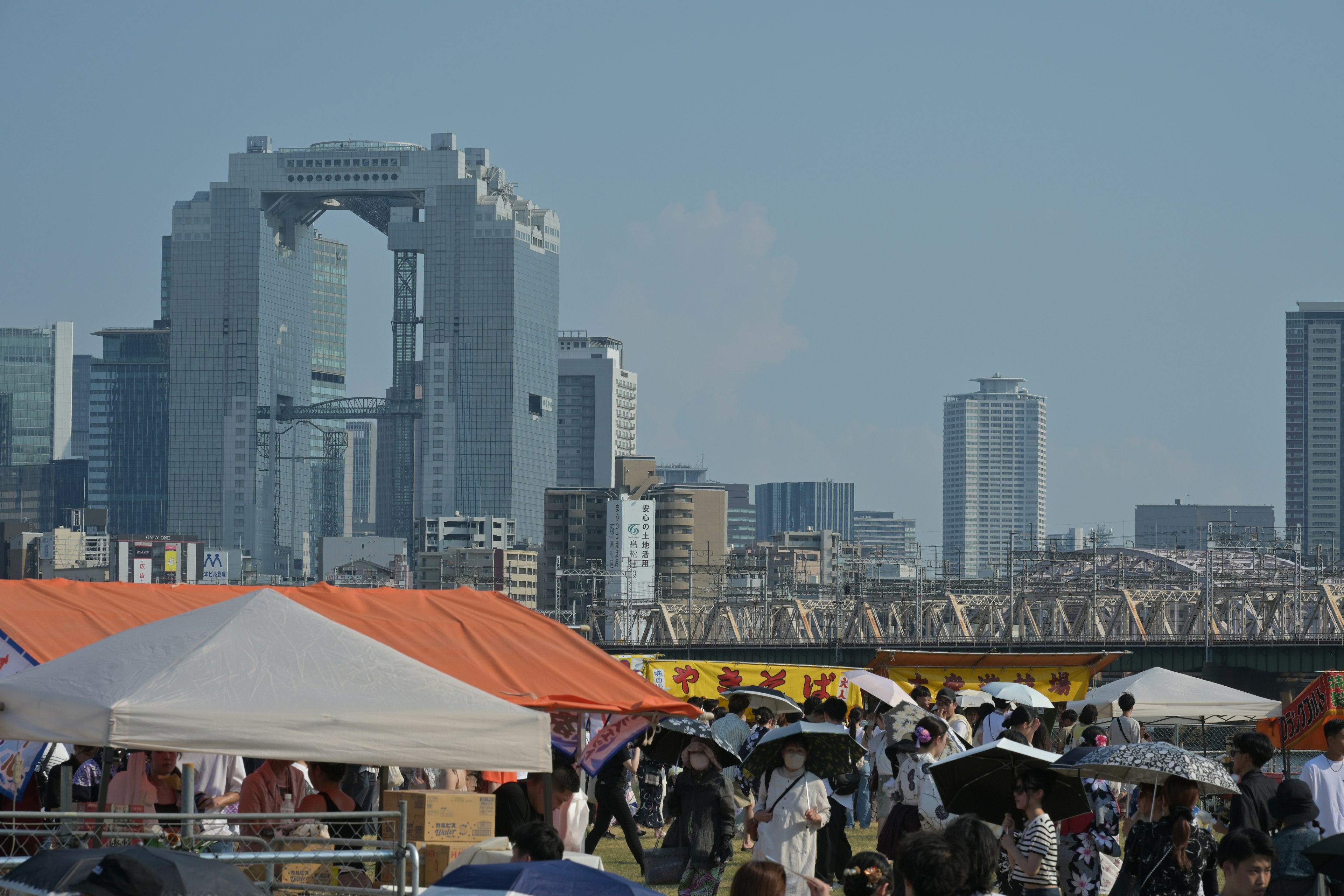 Cityscape featuring a crowd at an outdoor event with modern architecture