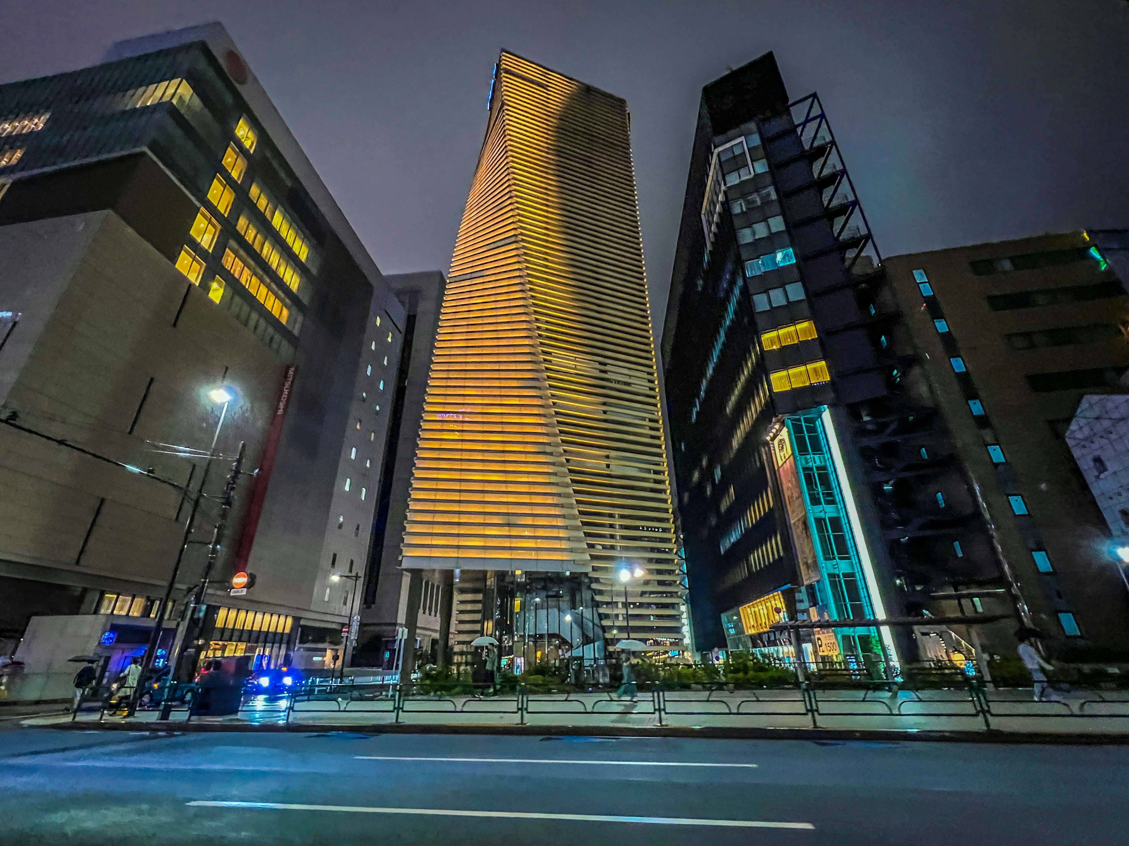 Urban skyline featuring towering buildings illuminated at night