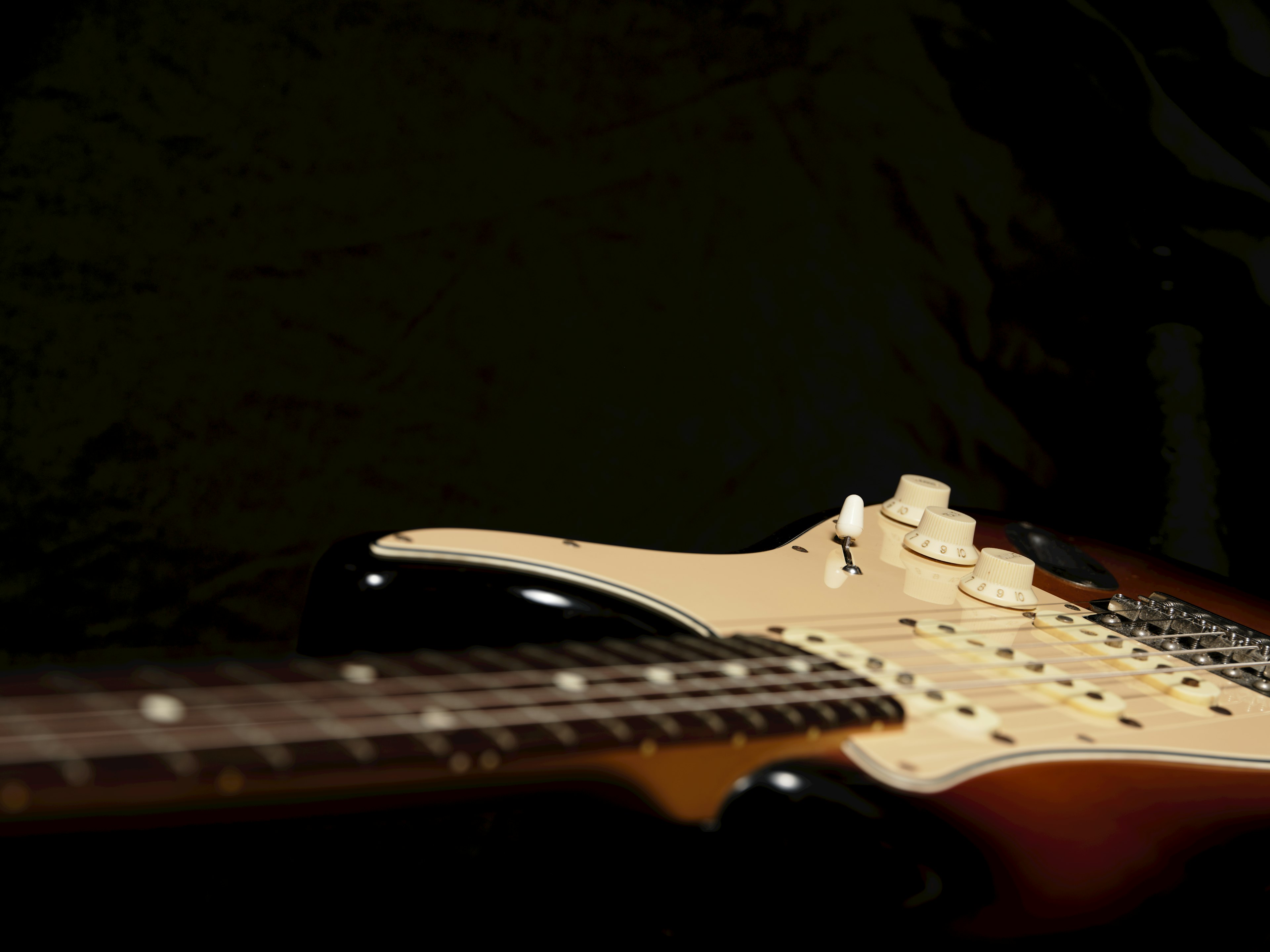 มุมมองด้านข้างของกีตาร์ Stratocaster บนพื้นหลังมืด