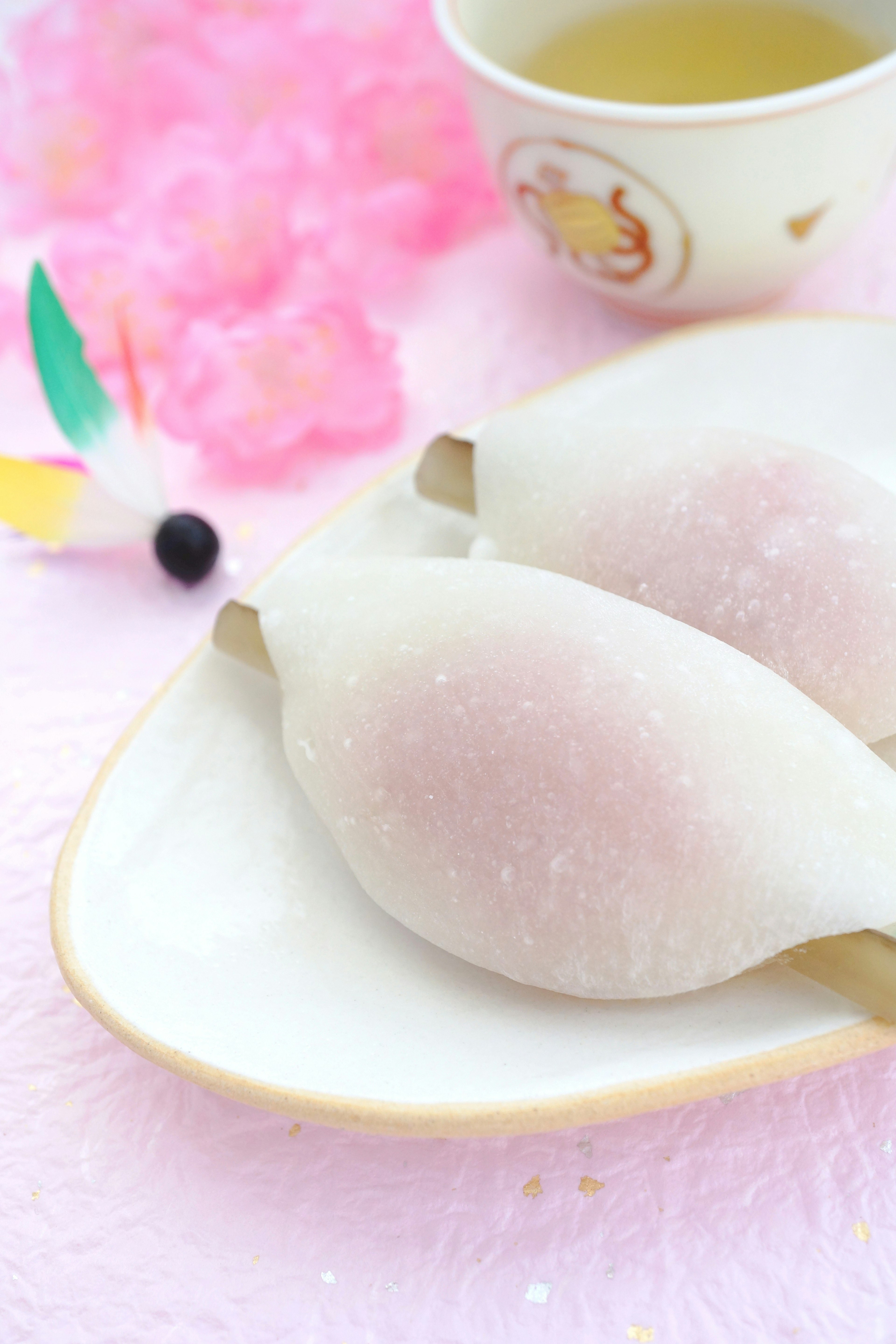 Image of white sweets on a plate with a cup of tea