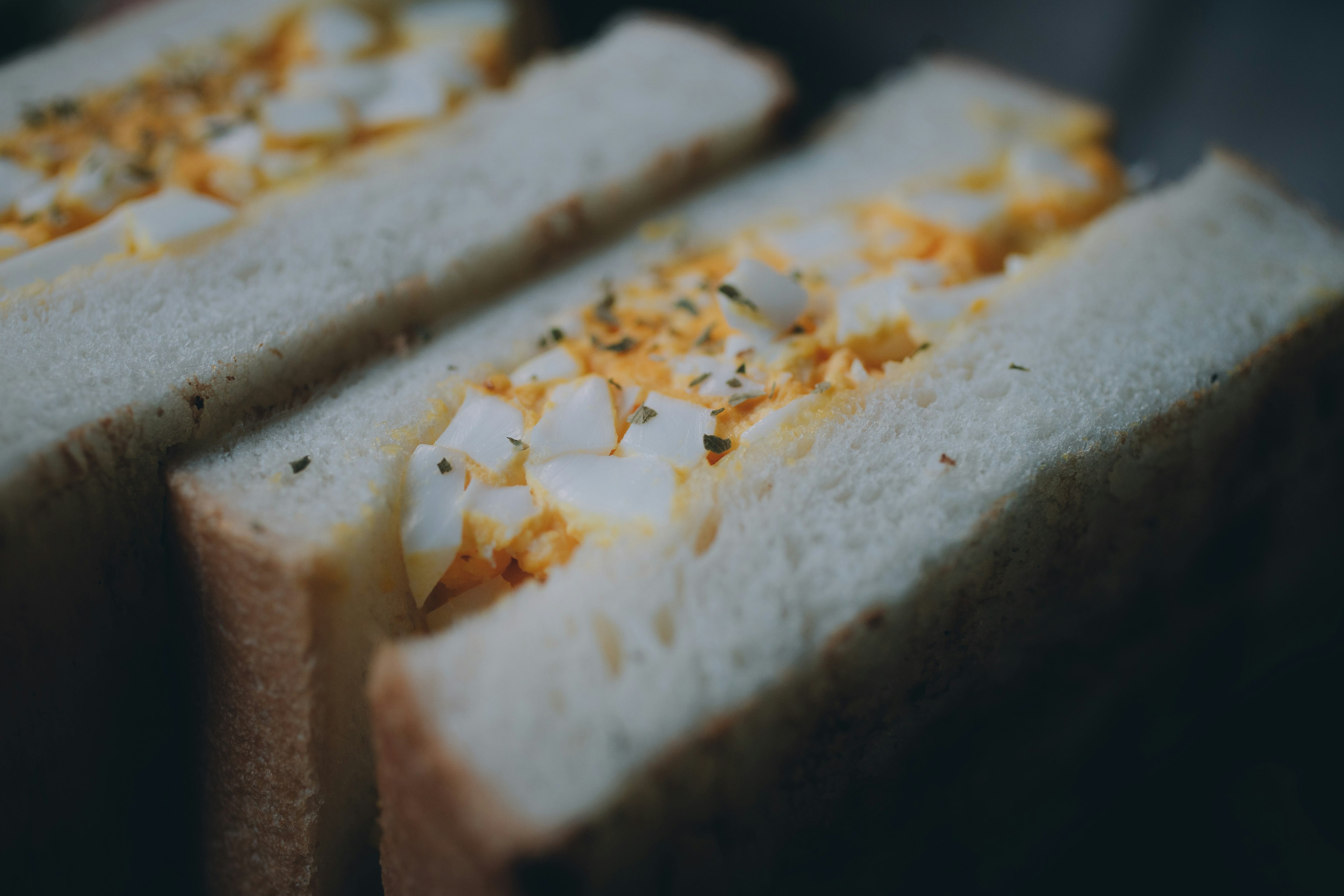 Nahaufnahme eines köstlichen Eiersandwichs, das die Füllung zeigt