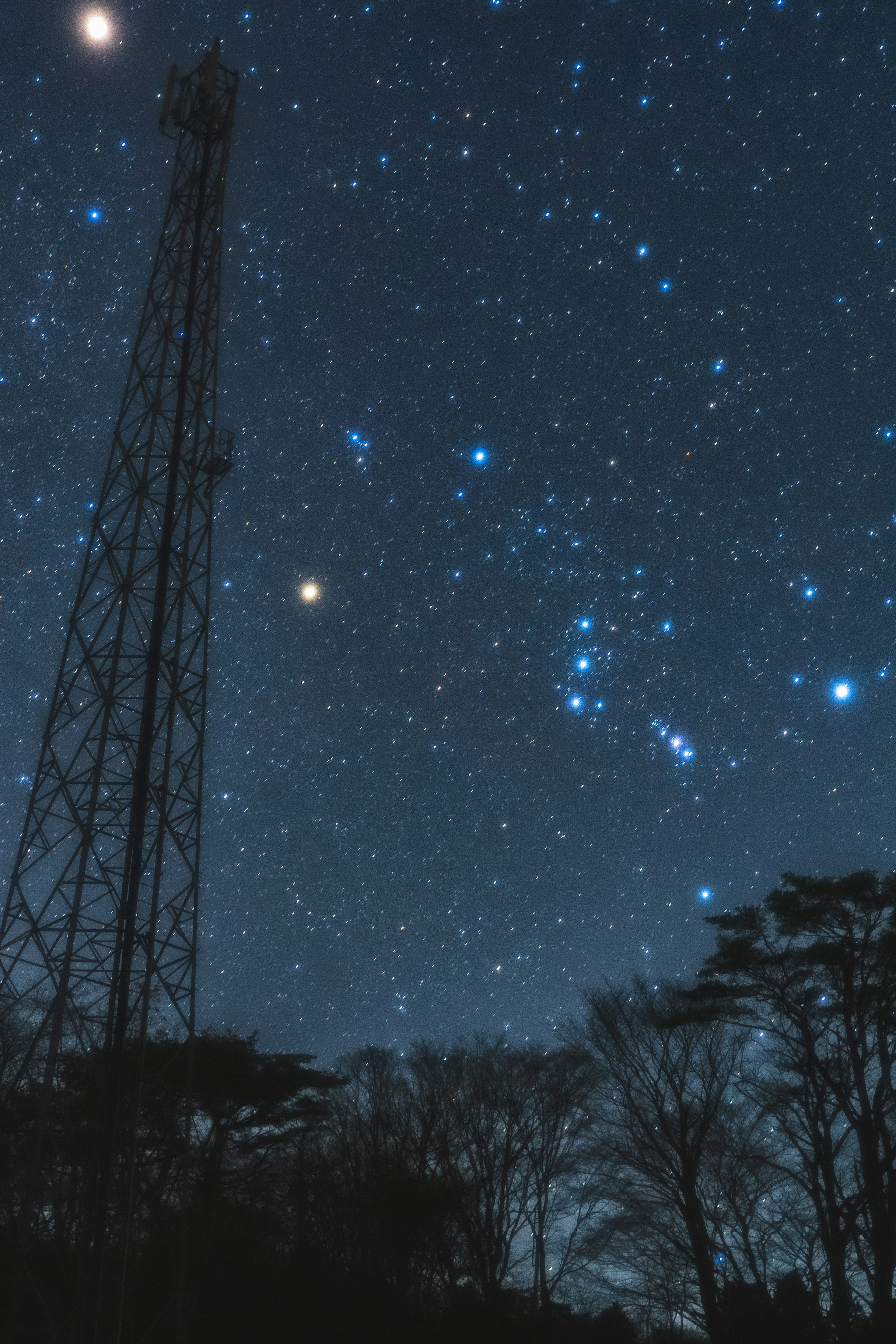 Night sky with stars and a radio tower