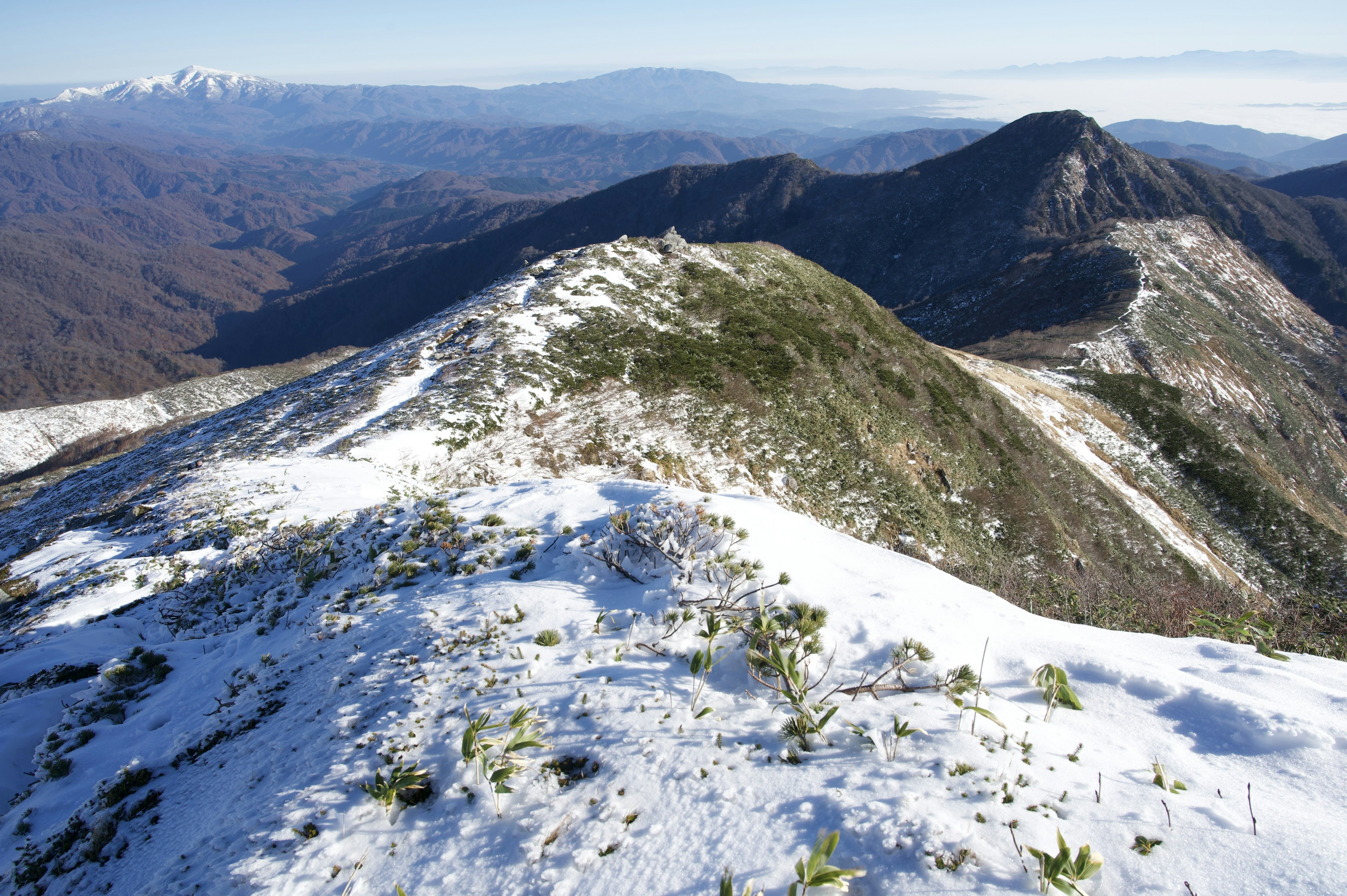 Verschneite Berglandschaft mit einer Bergkette im Hintergrund