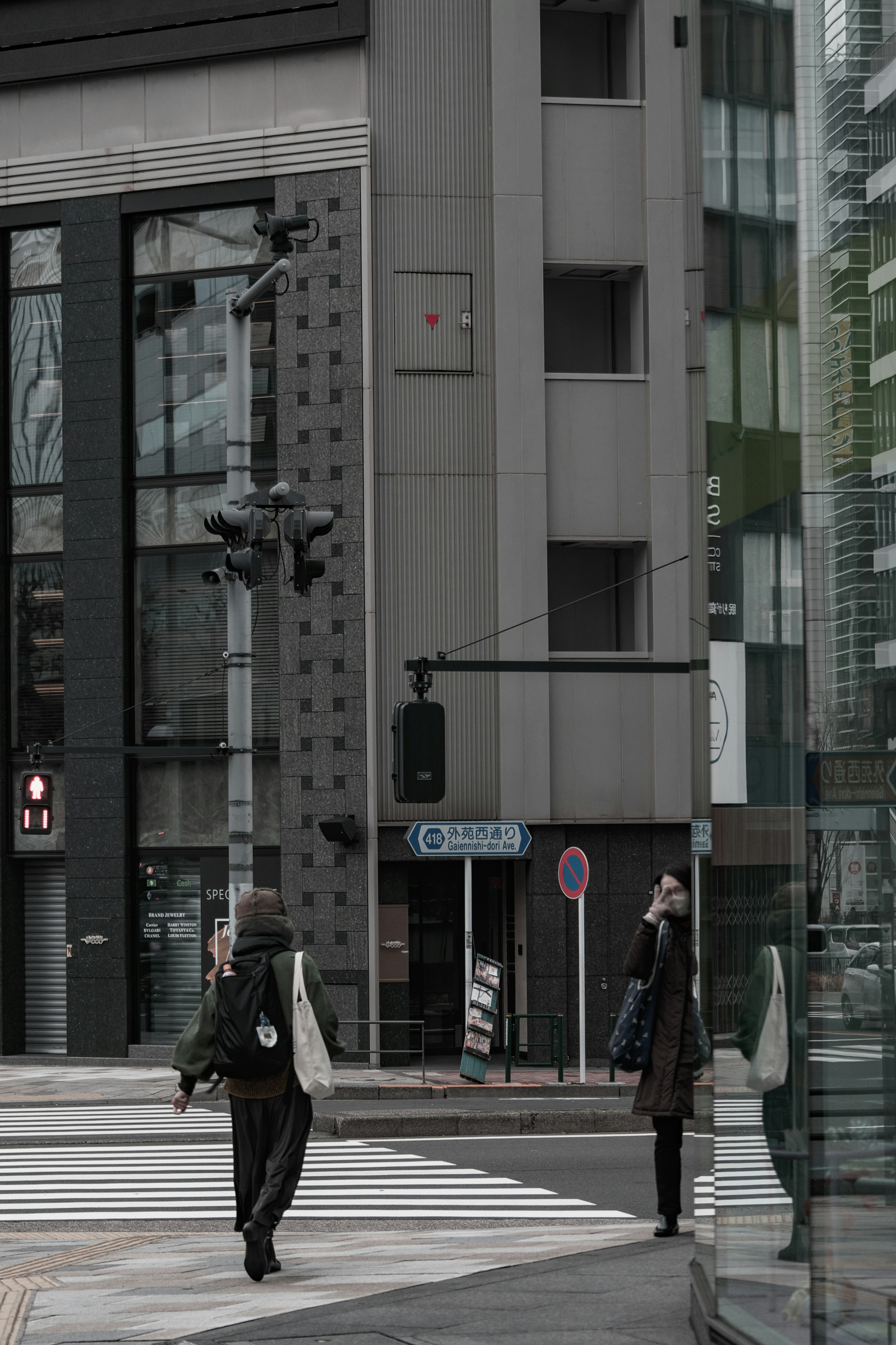 People waiting at an urban intersection with modern buildings