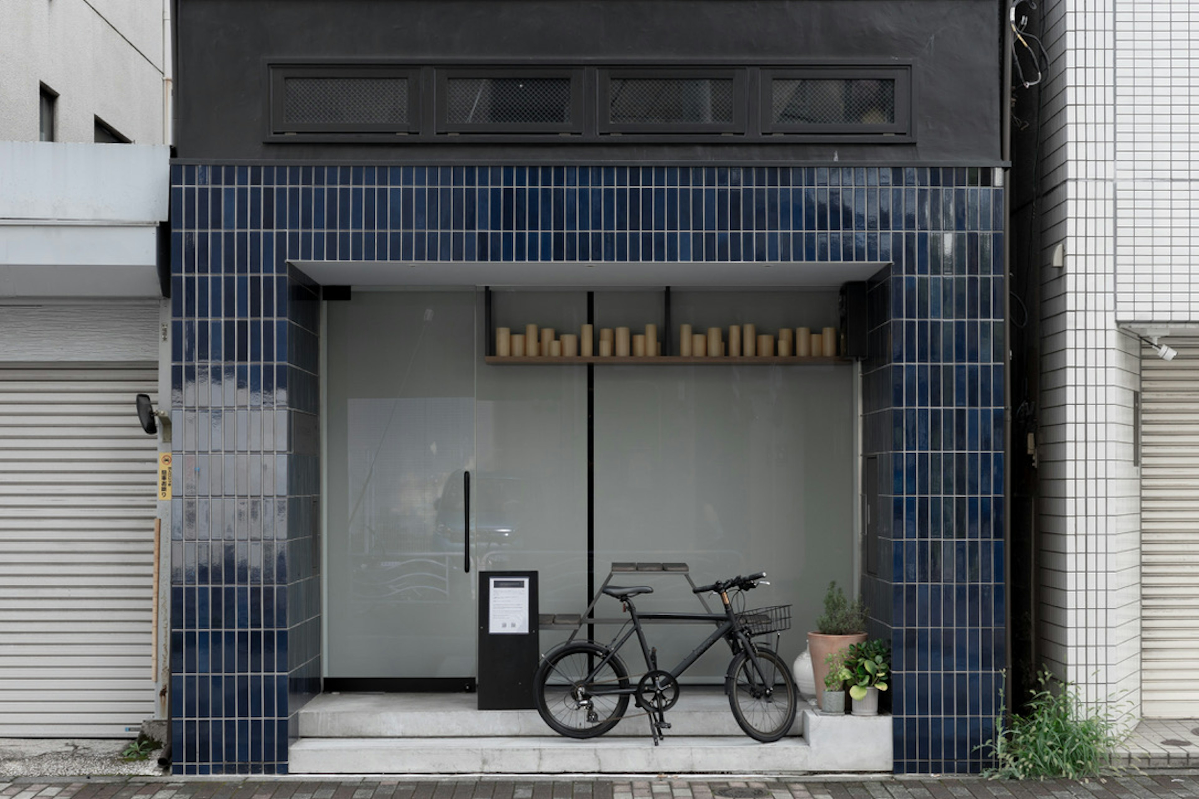 Modern cafe entrance with a bicycle parked outside