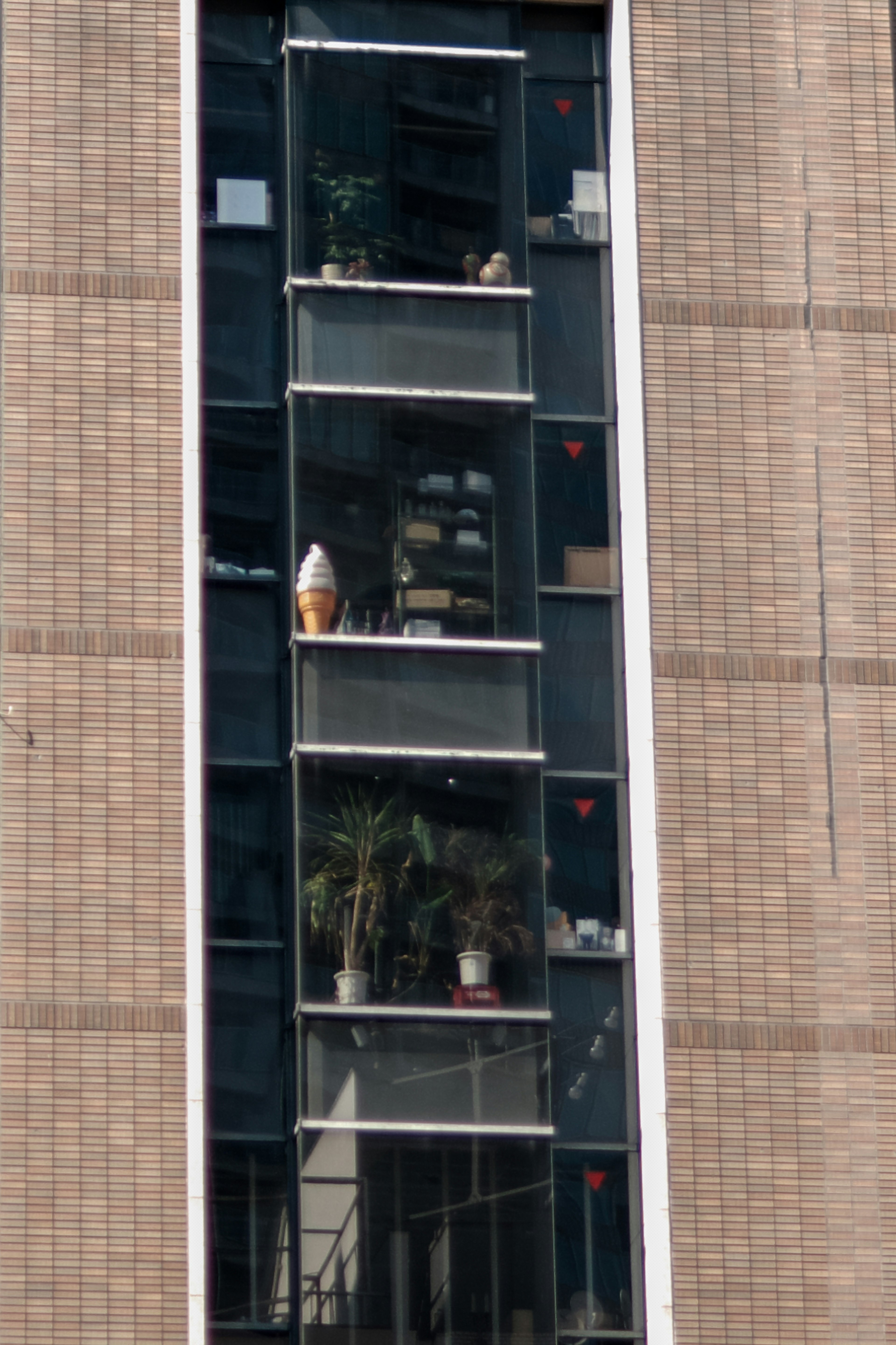 Balconies with plants visible on a high-rise building