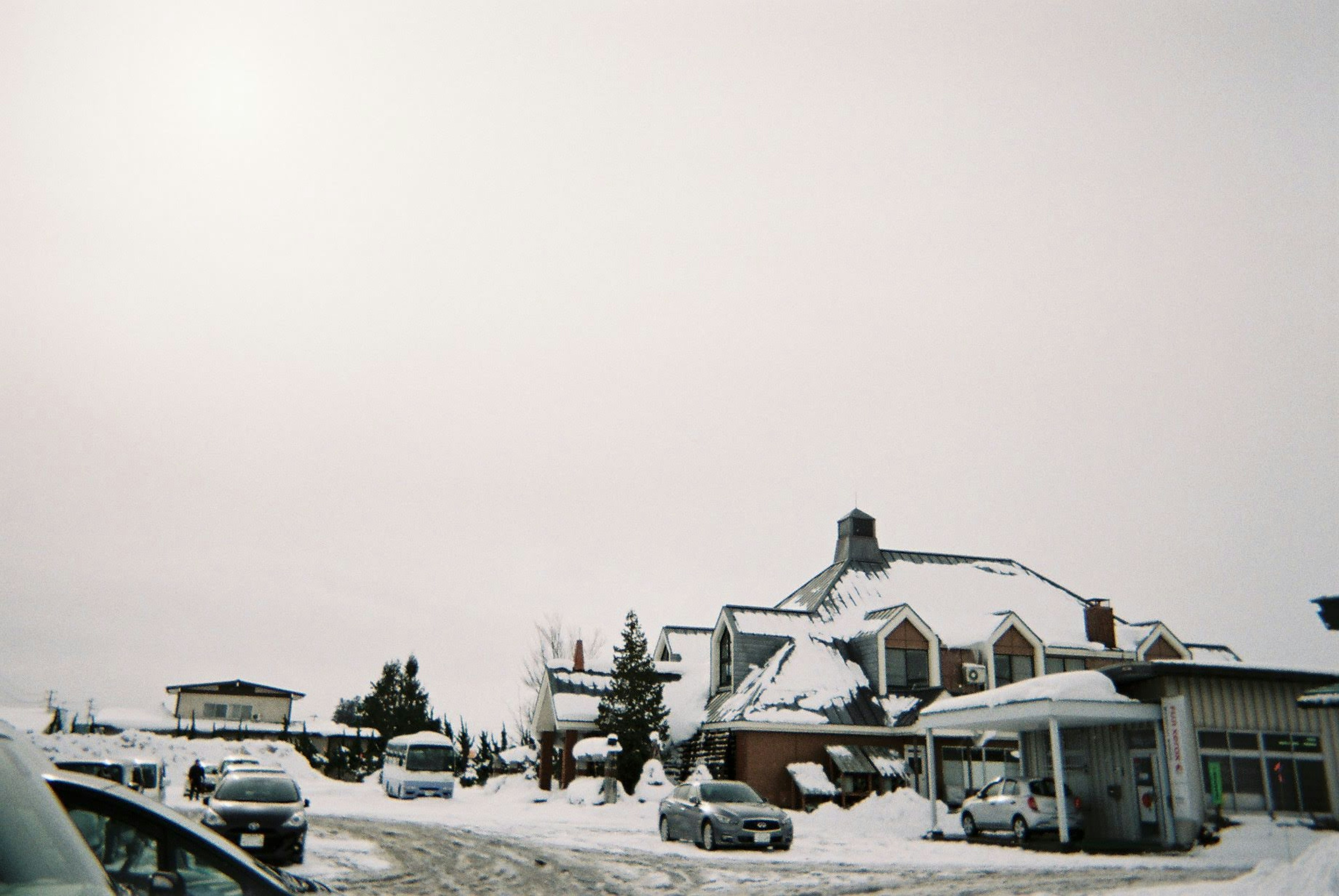 Snow-covered buildings under a cloudy sky