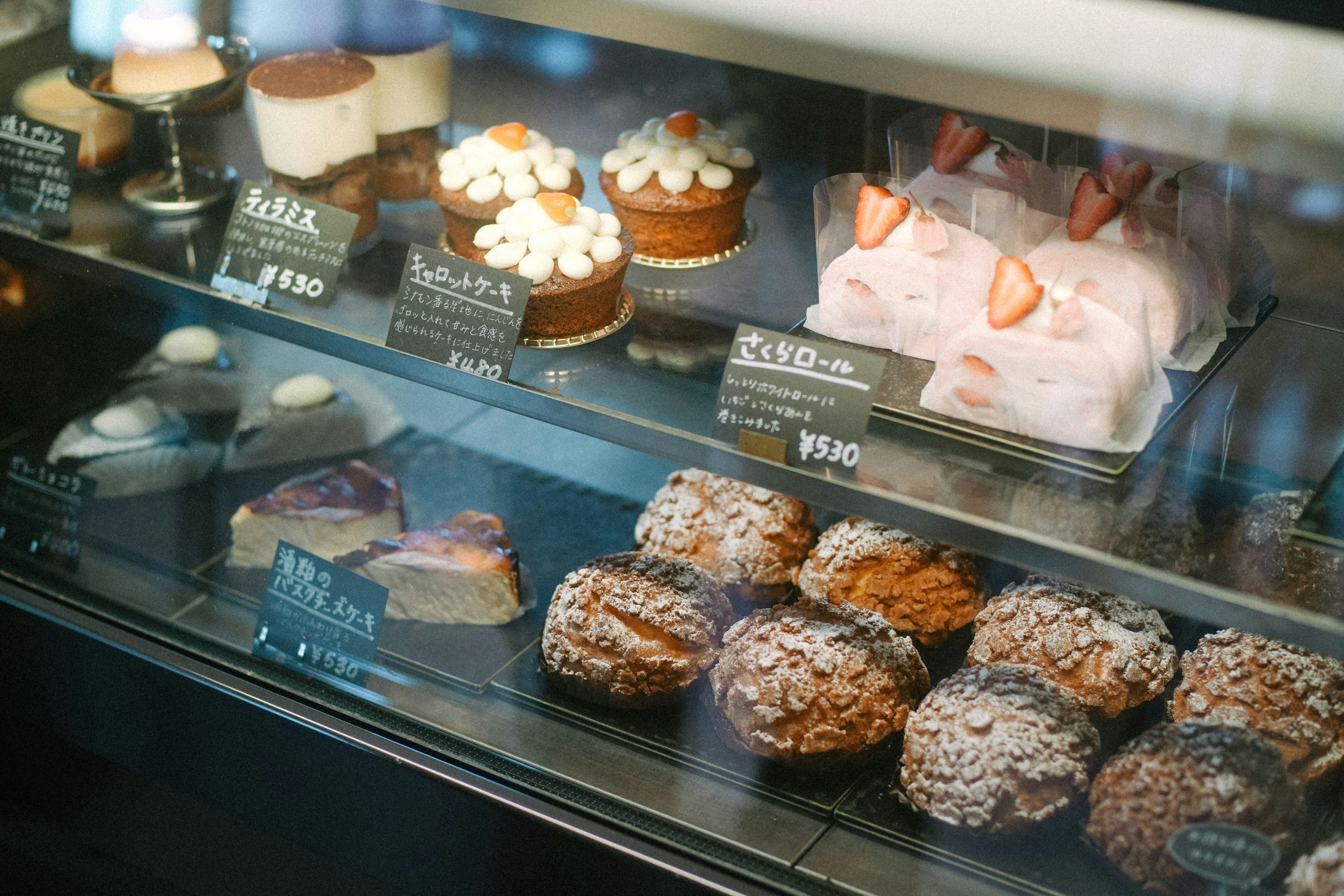 Display case filled with various desserts and cakes