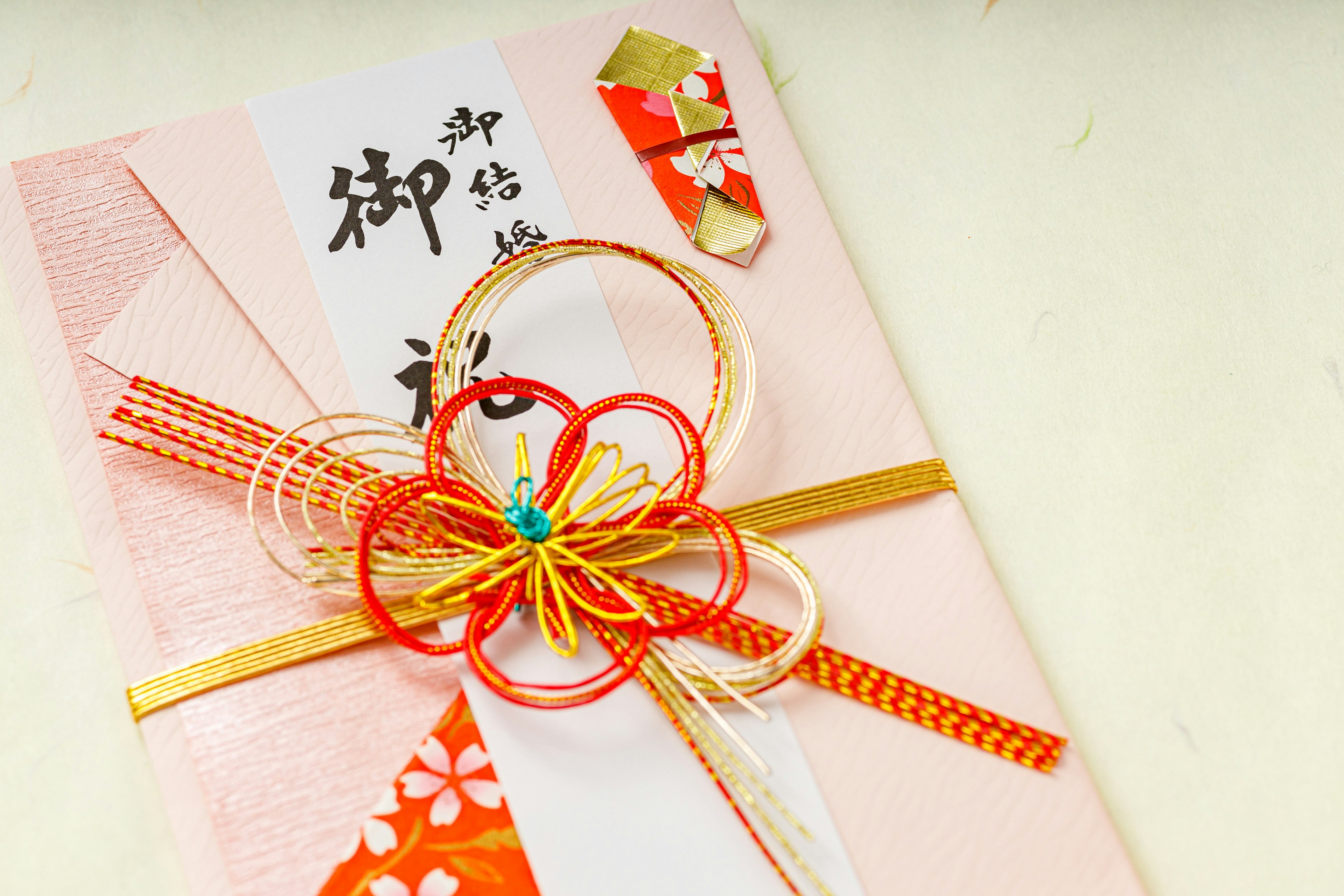 Decorative Japanese gift envelope adorned with red and gold ribbons