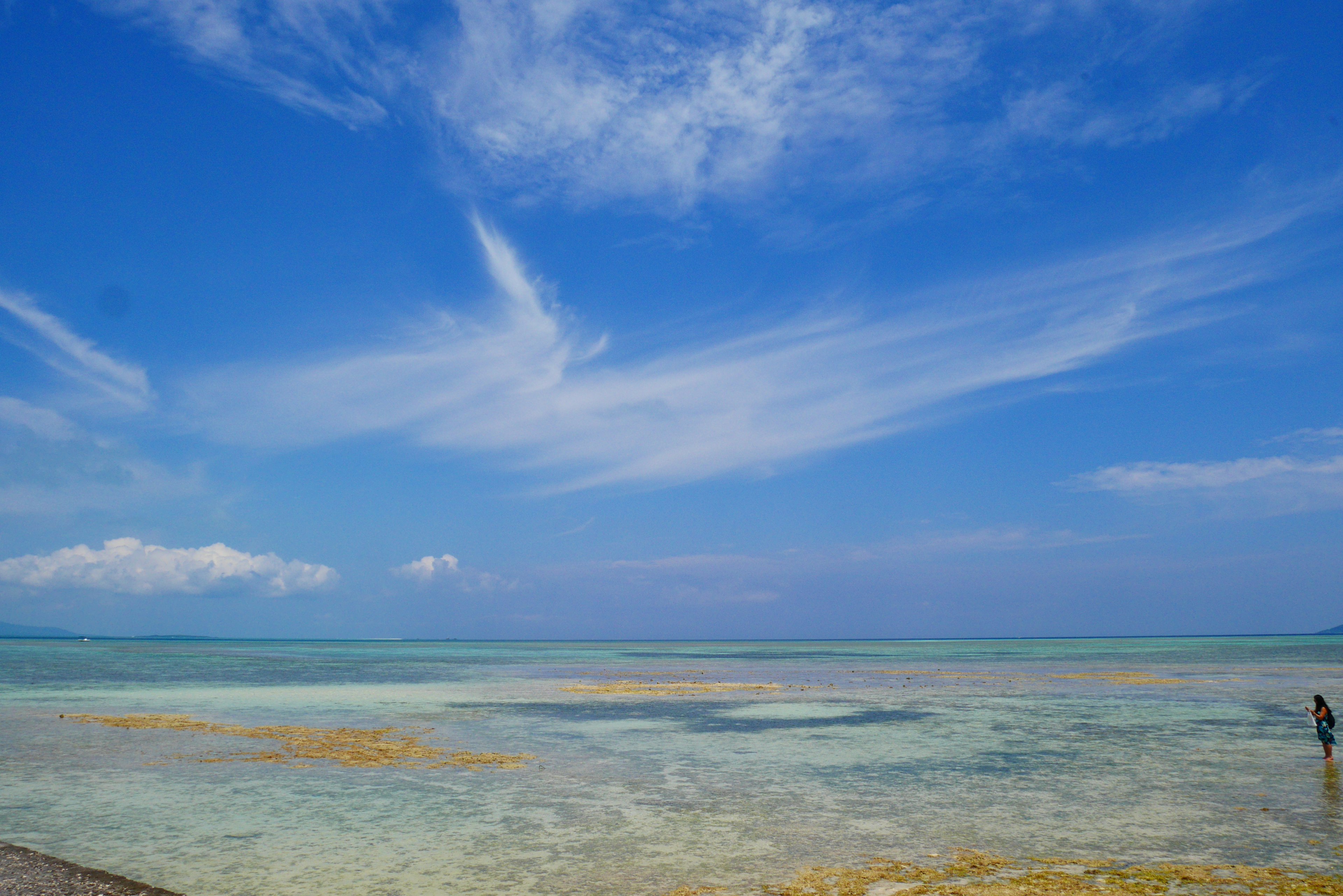 Bellissimo paesaggio di mare e cielo blu con una persona in piedi