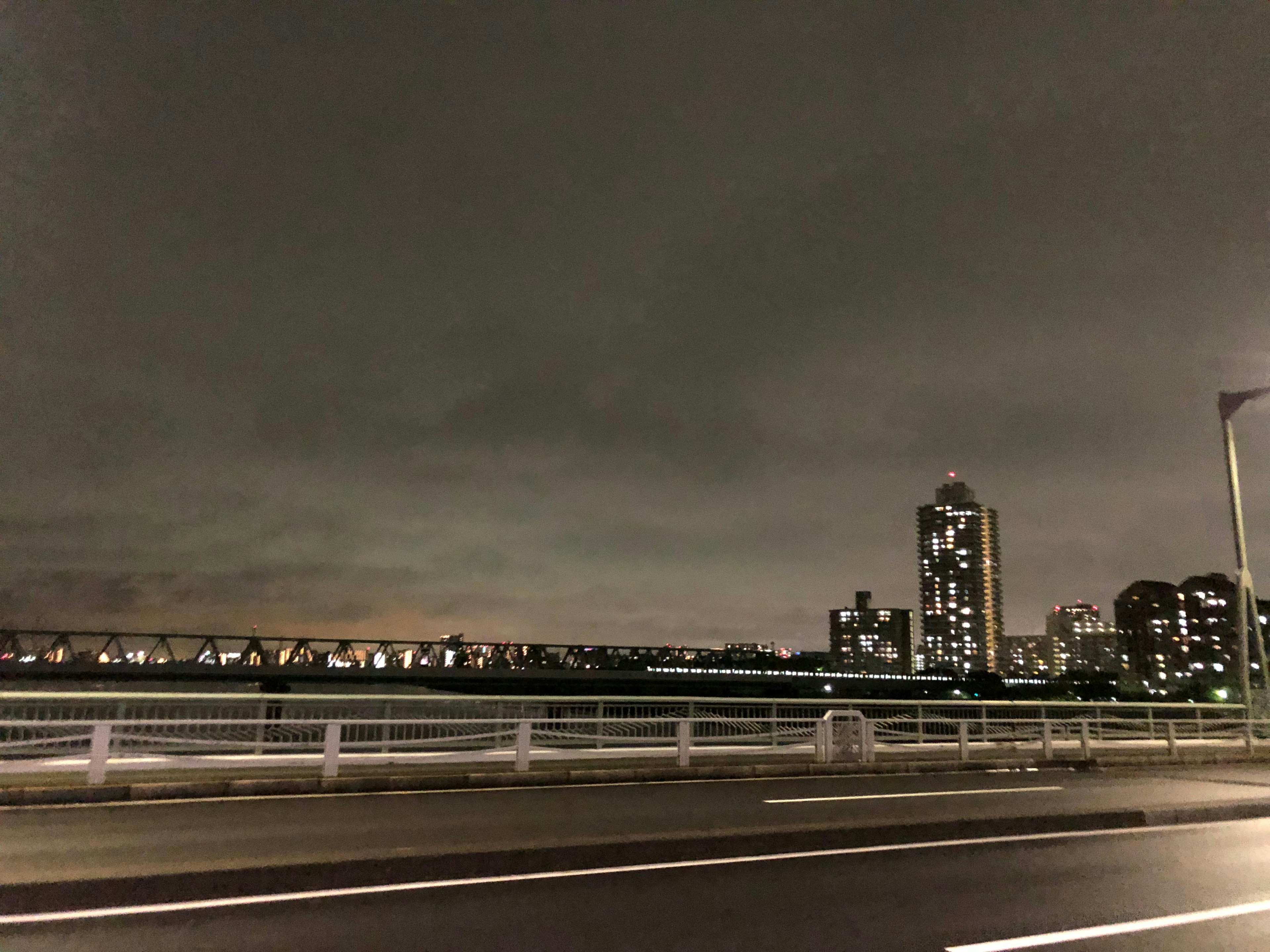 City skyline at night with illuminated buildings and a dark sky