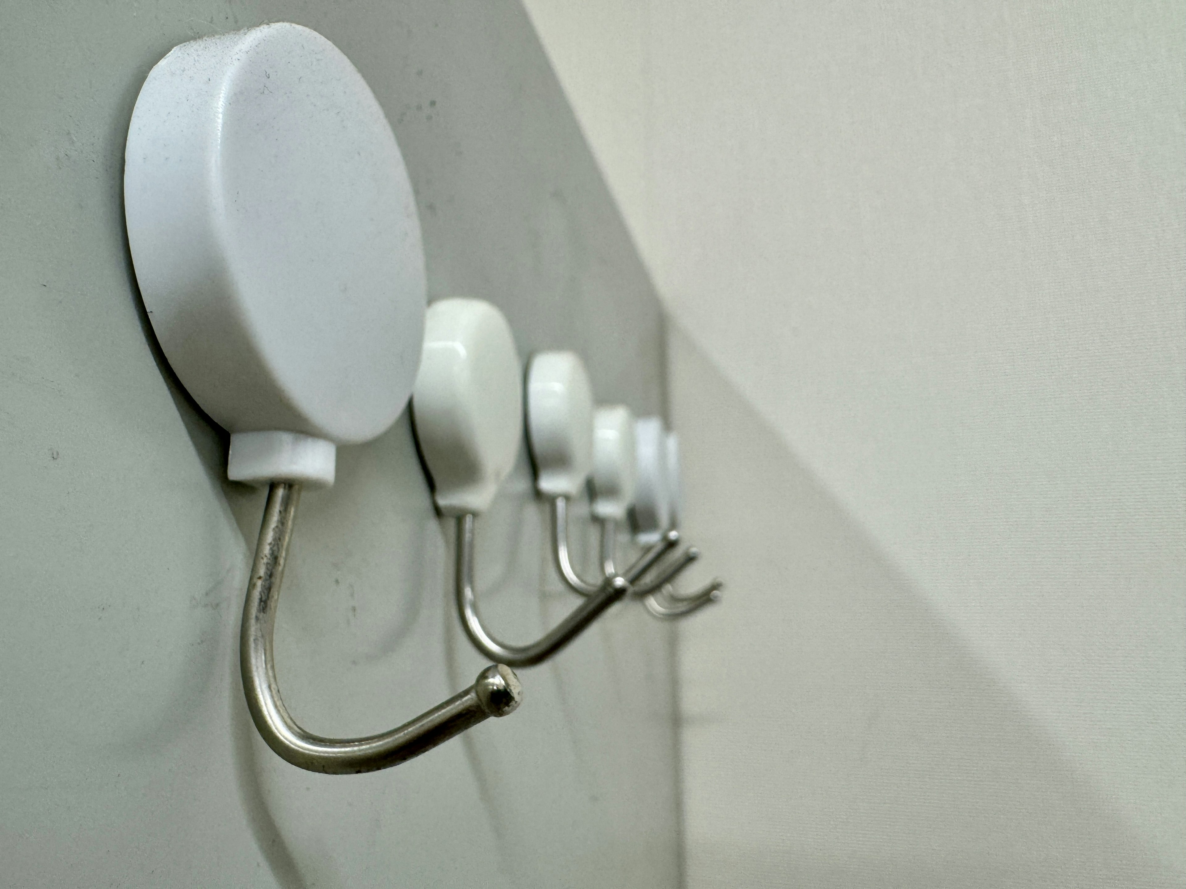 Image of white hooks mounted on a wall