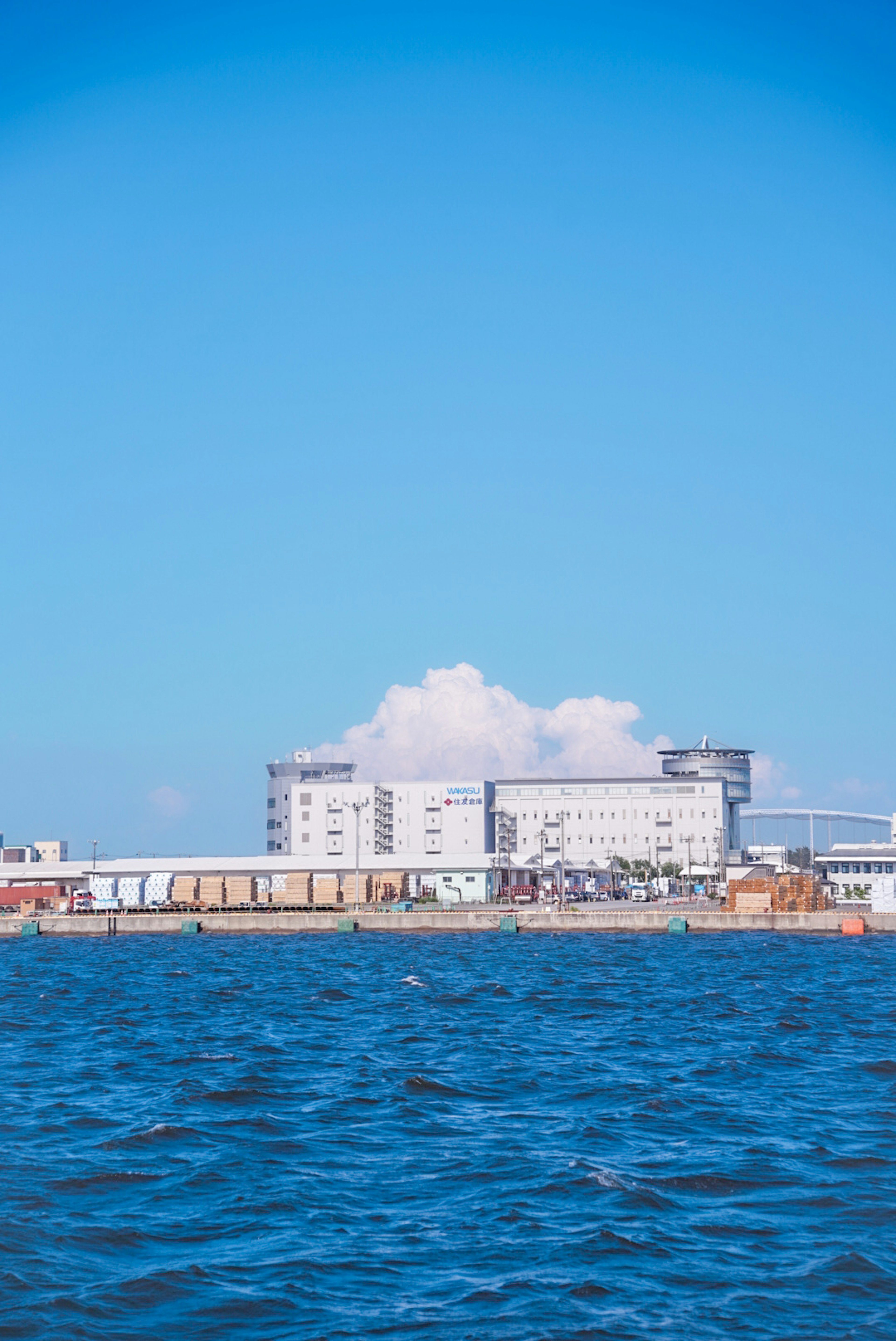 Modern building by the blue ocean under a bright sky