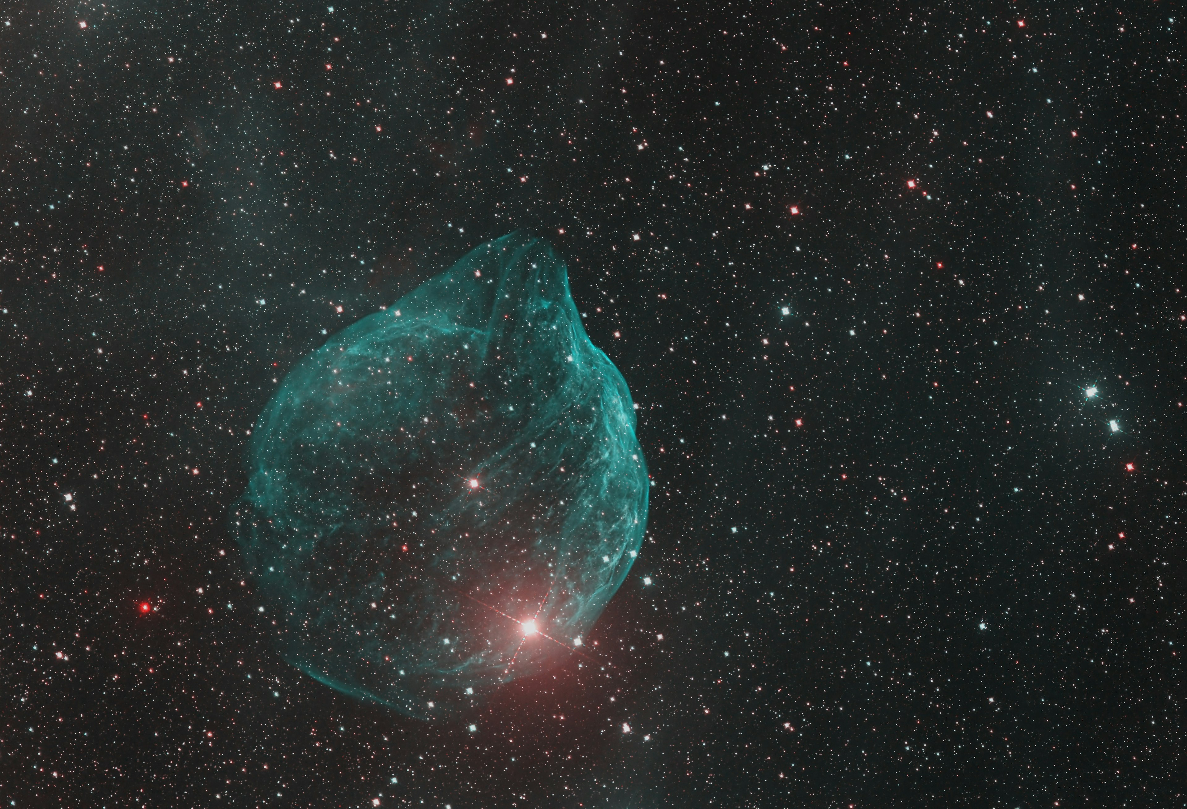 Blue glowing bubble-like nebula in a starry sky