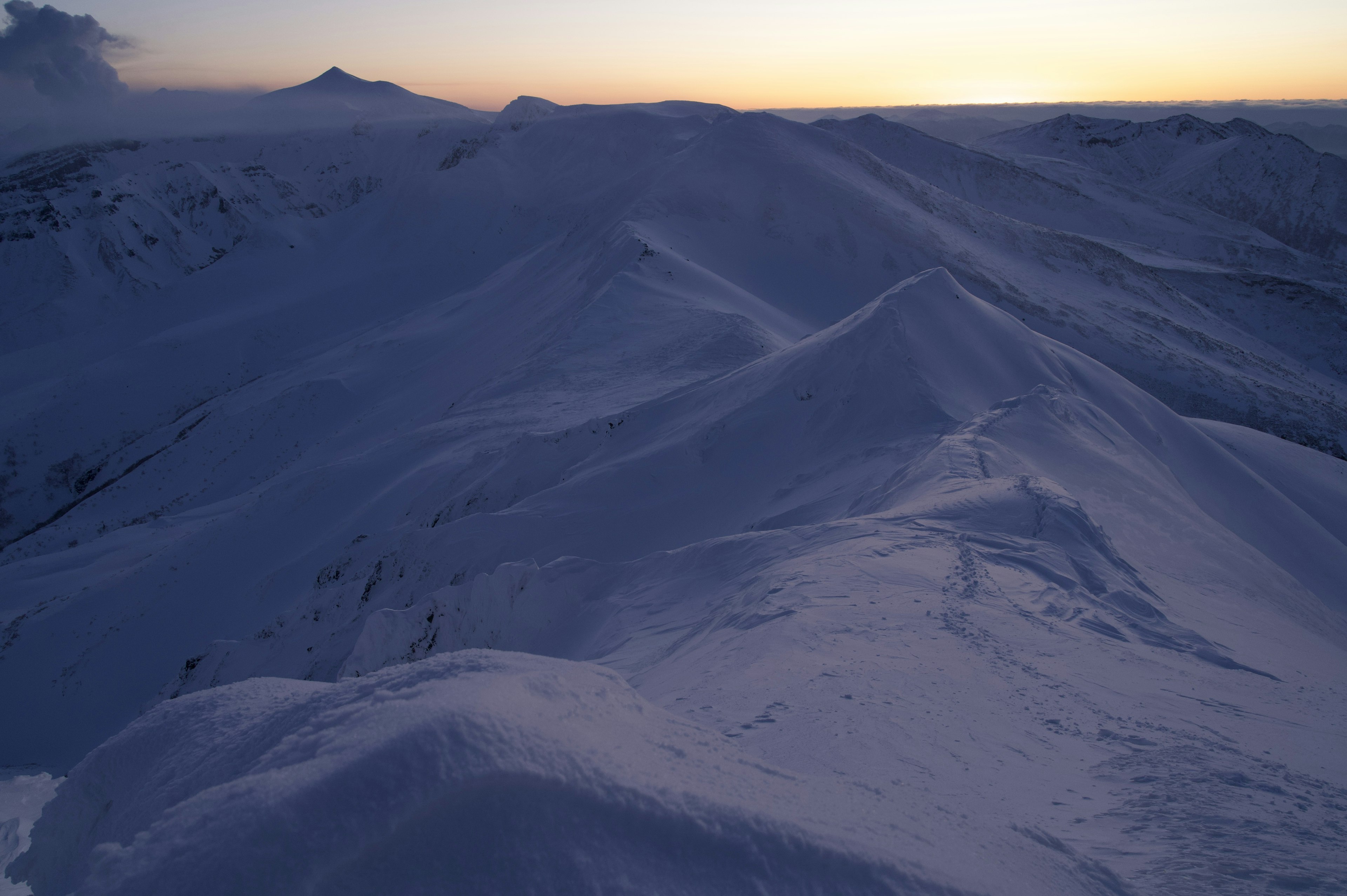 Snow-covered mountain landscape with twilight light