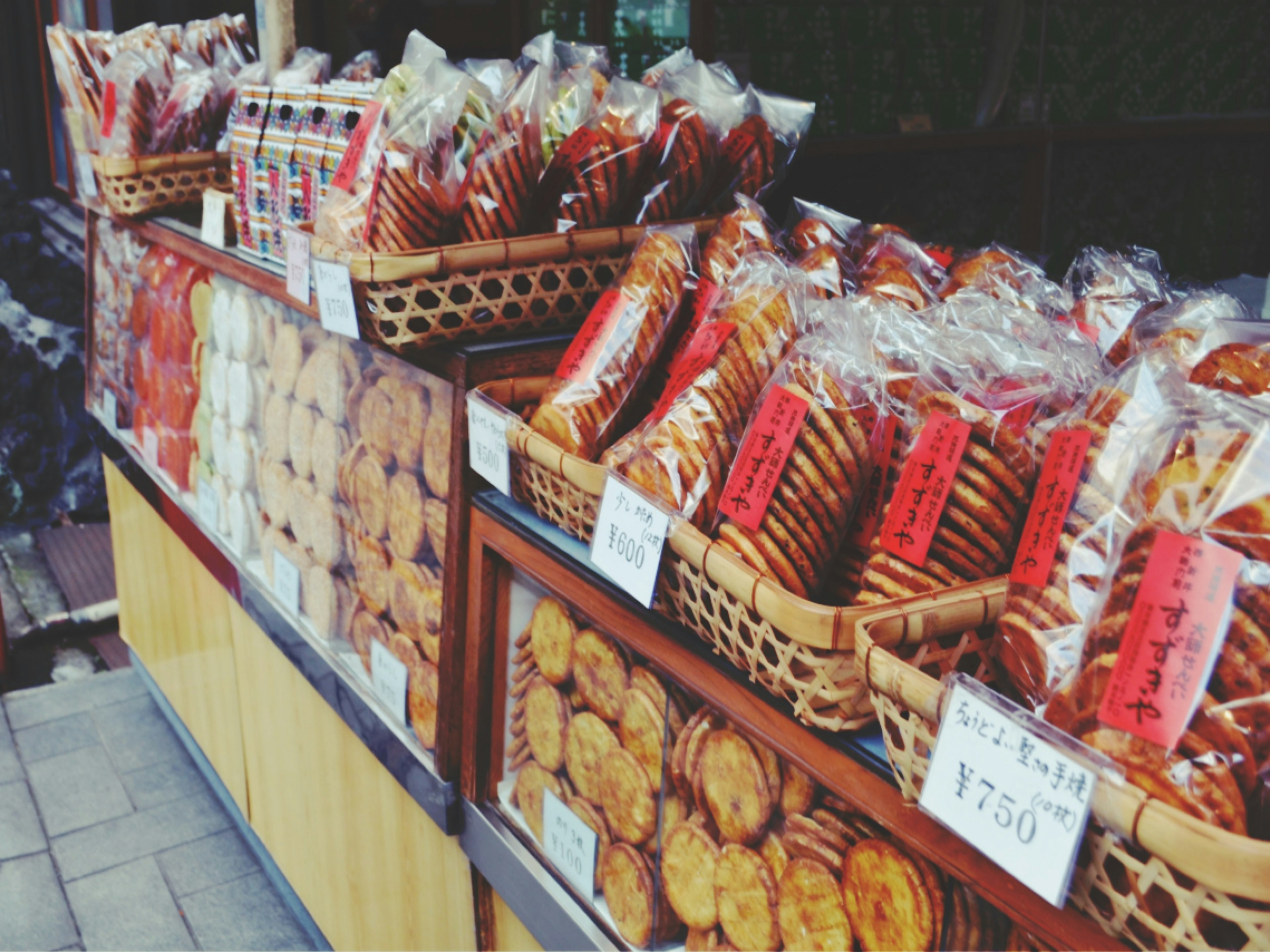 A scene of various types of baked goods displayed at a market stall