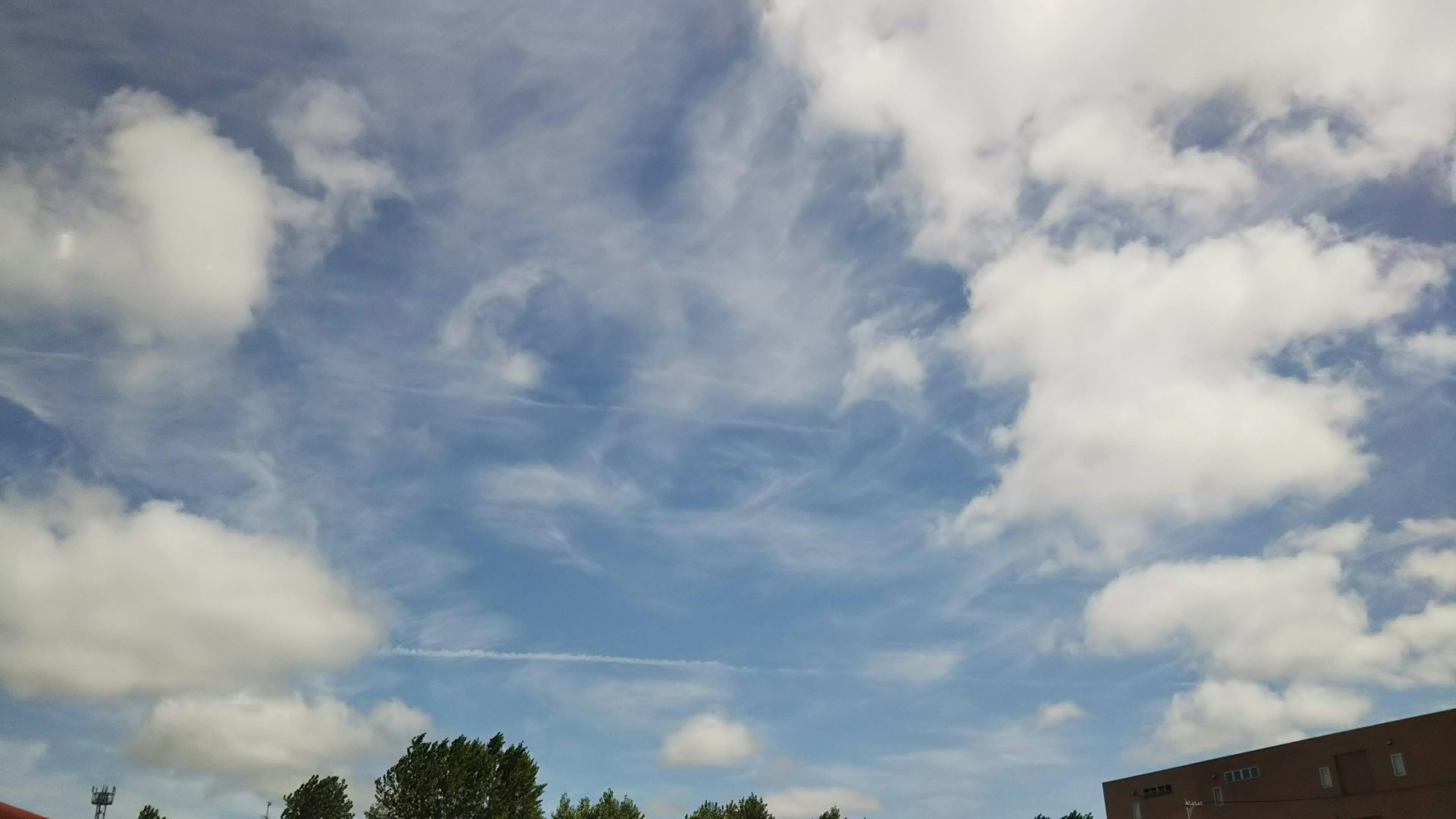 Un paisaje con cielo azul y nubes blancas esponjosas