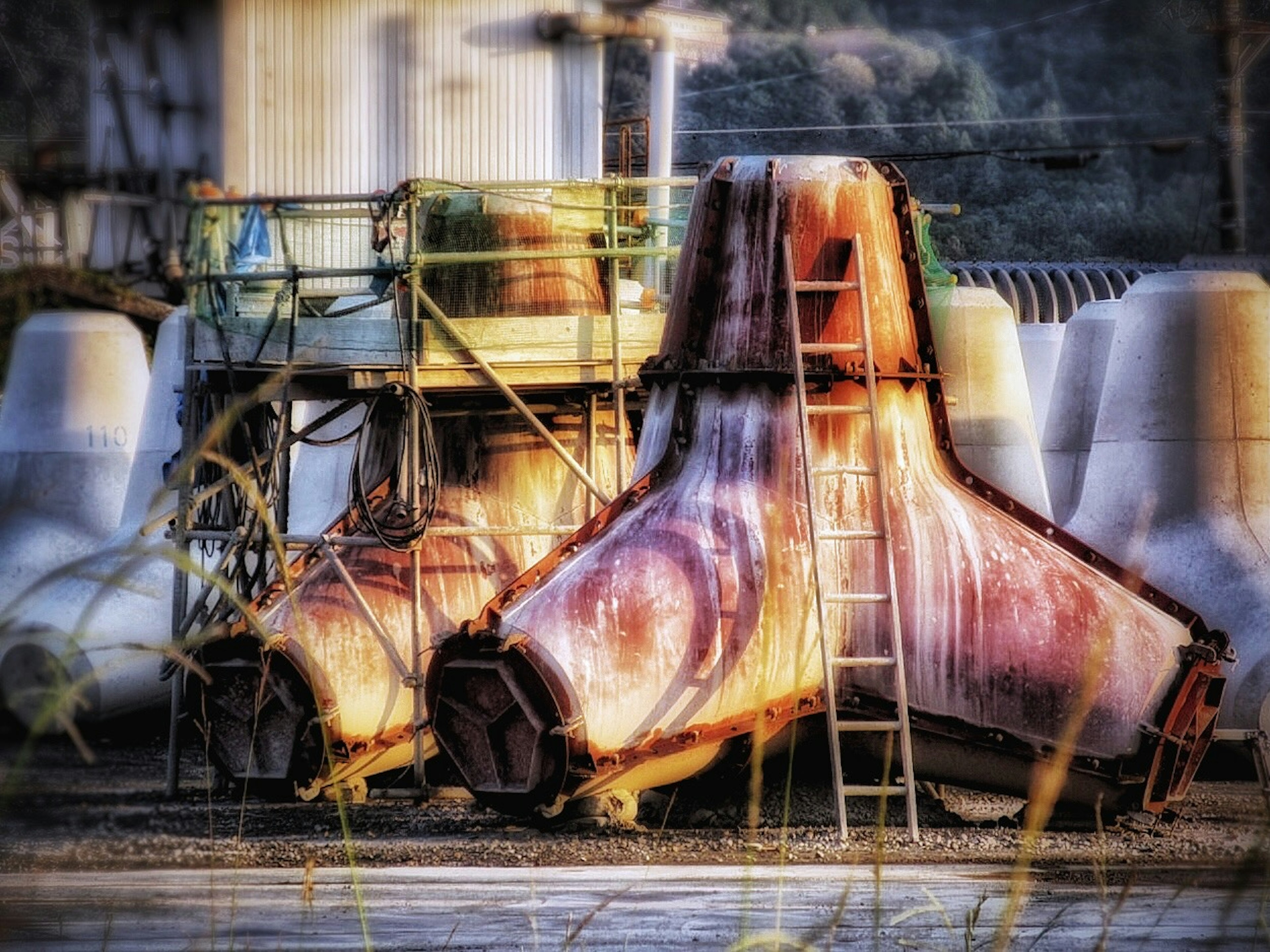 Rusty industrial machinery with scaffolding in an outdoor setting