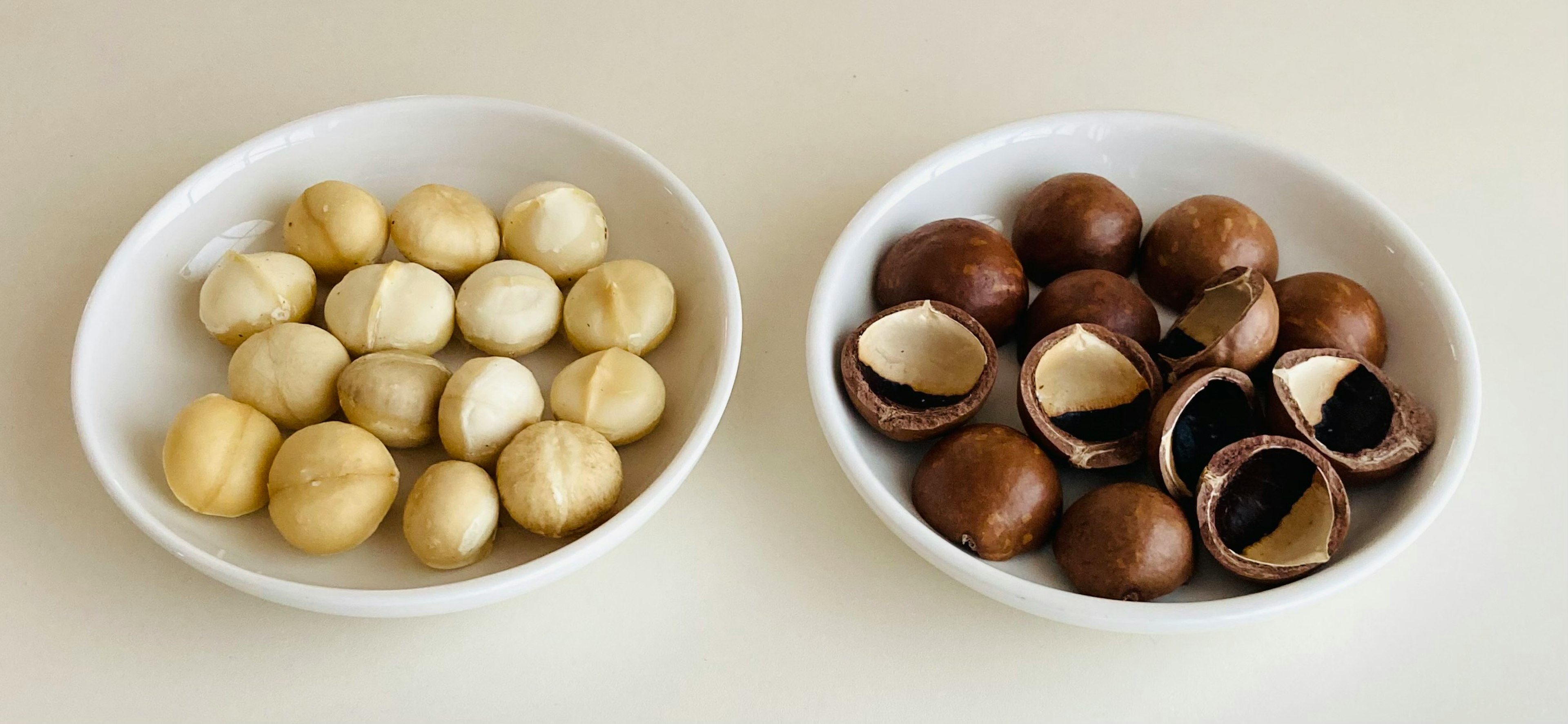 Bowls of macadamia nuts in white and brown varieties