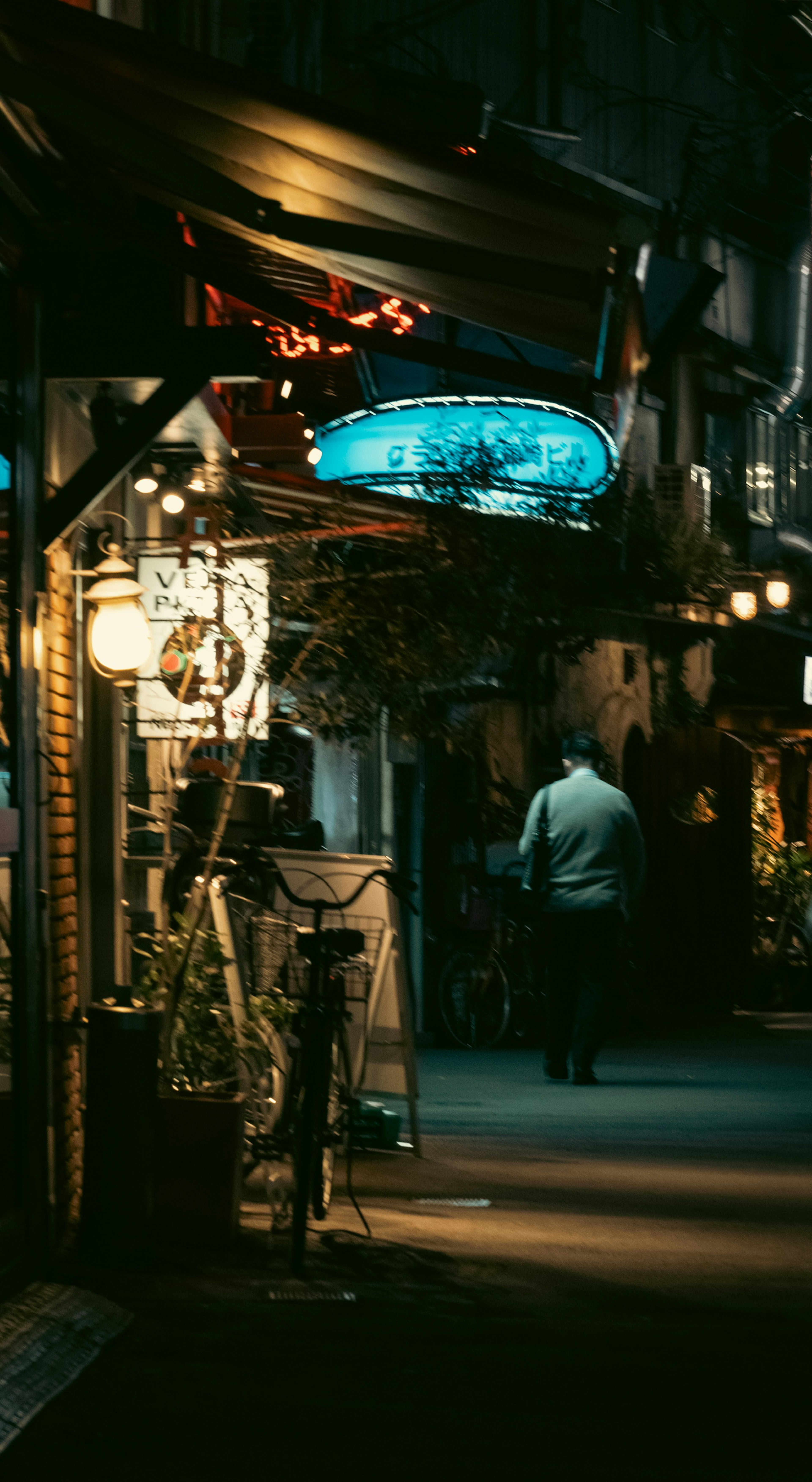 A street with illuminated restaurant signs at night