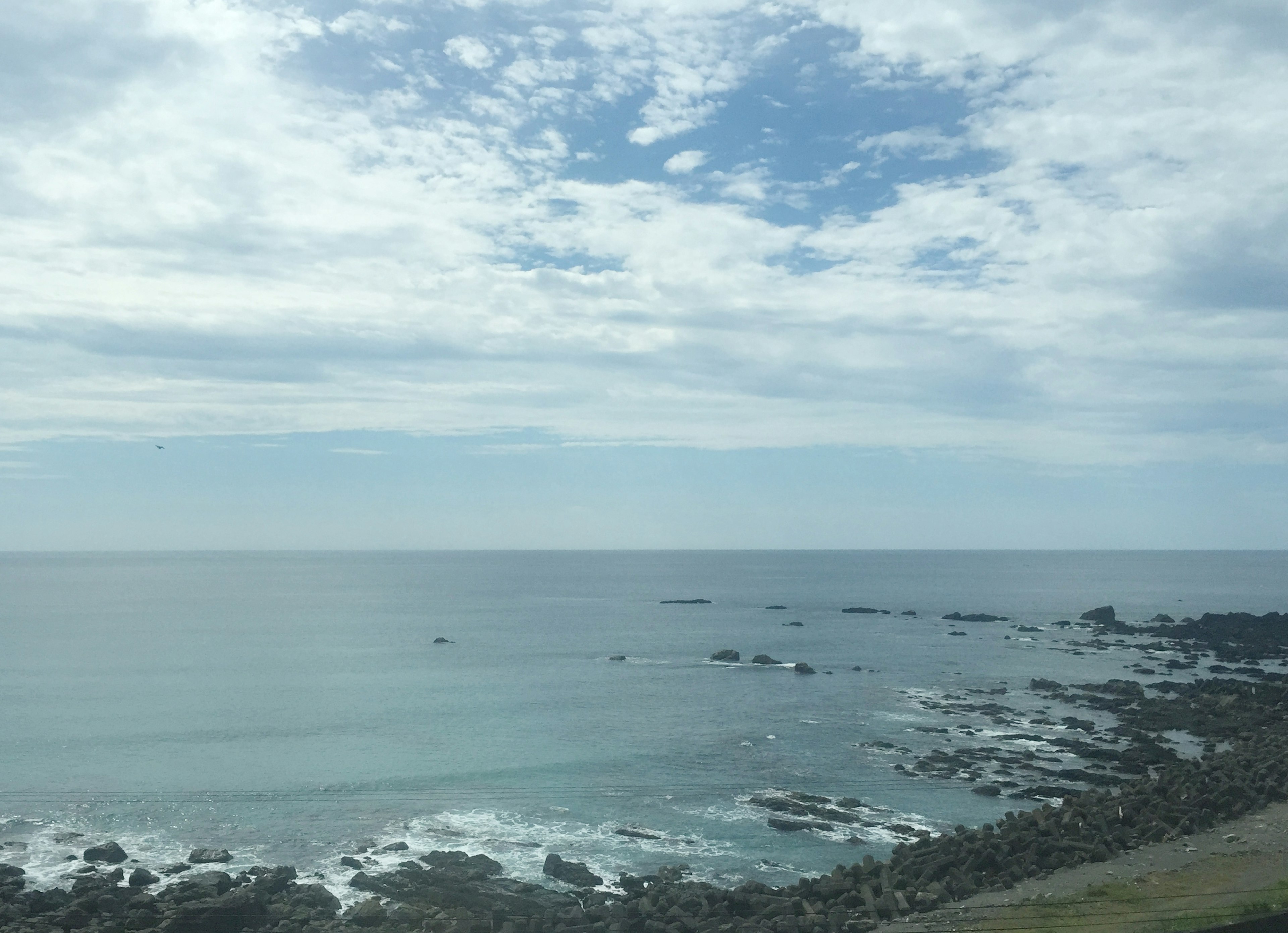 Coastal view featuring blue ocean and rocky shoreline