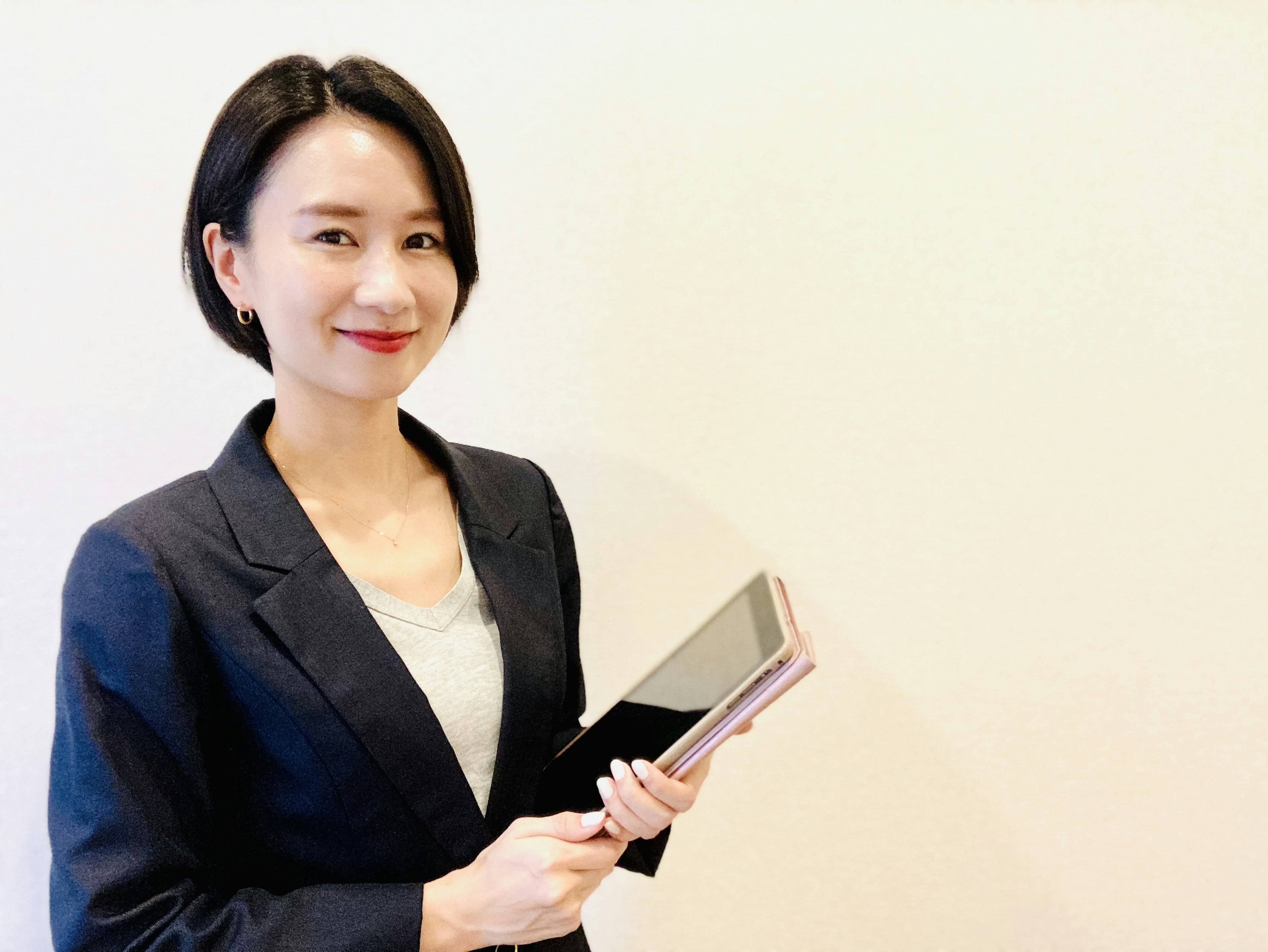 Woman in business suit holding a tablet