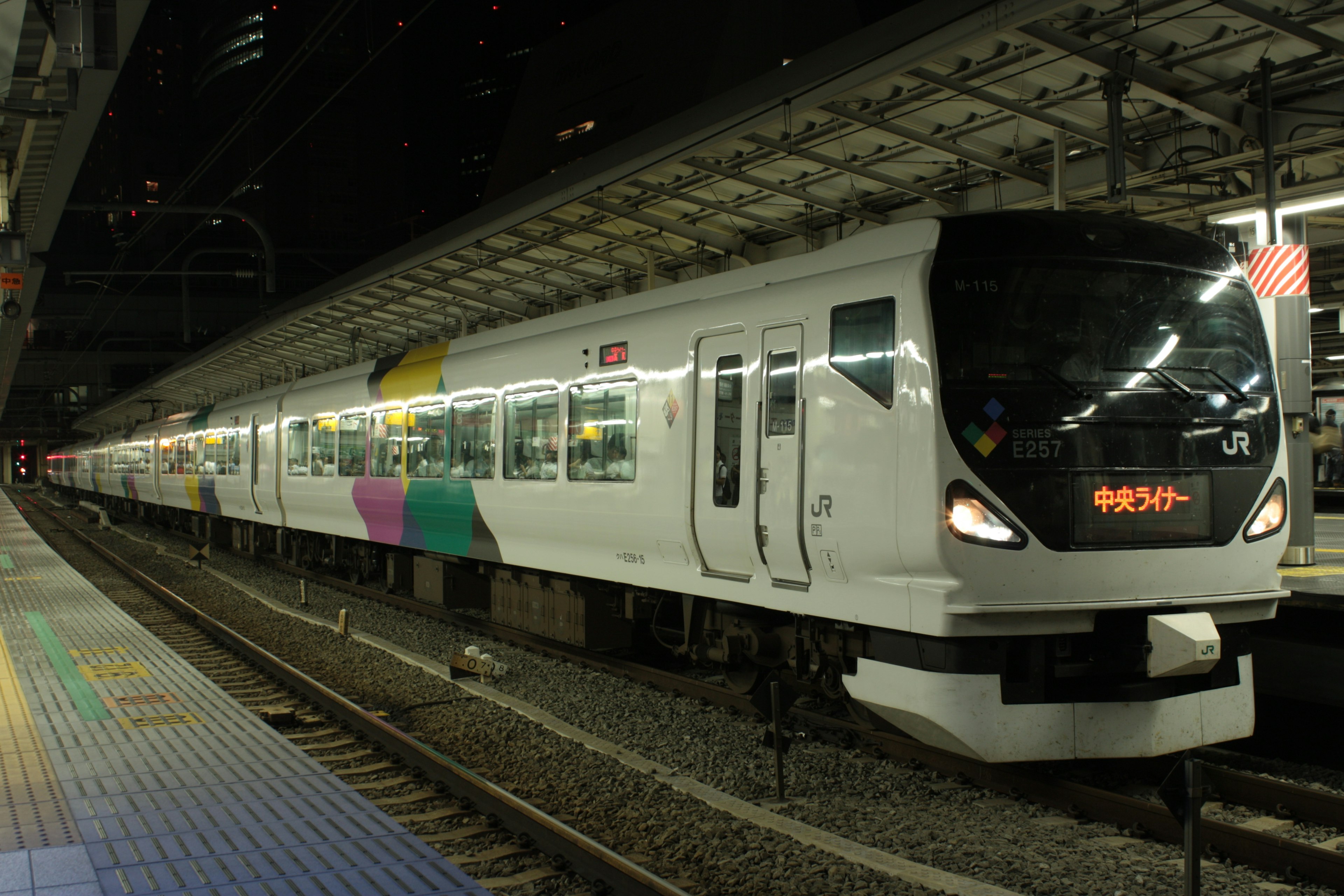 Tren blanco con diseños coloridos en estación nocturna