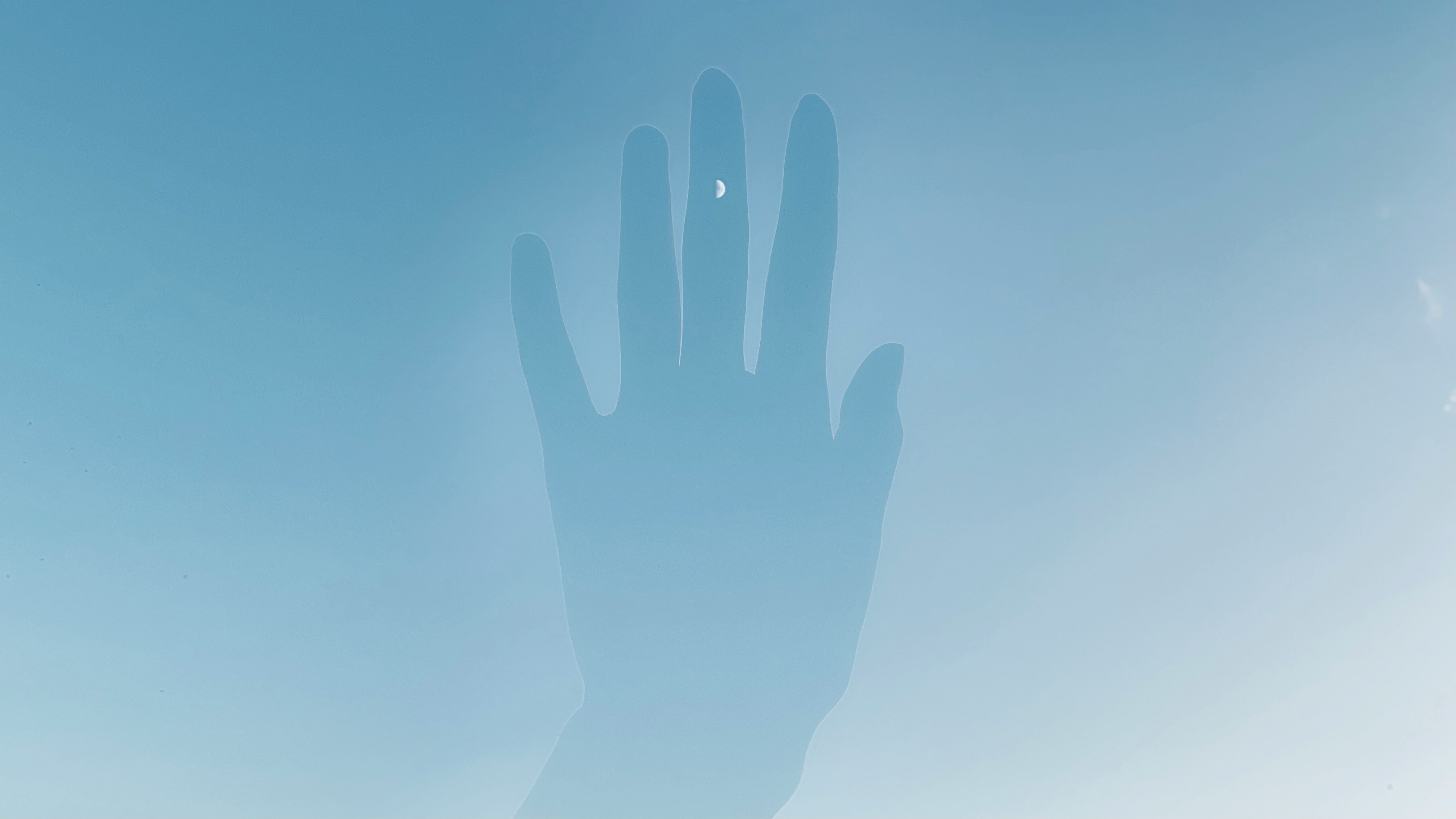 Silhouette of a hand against a blue background