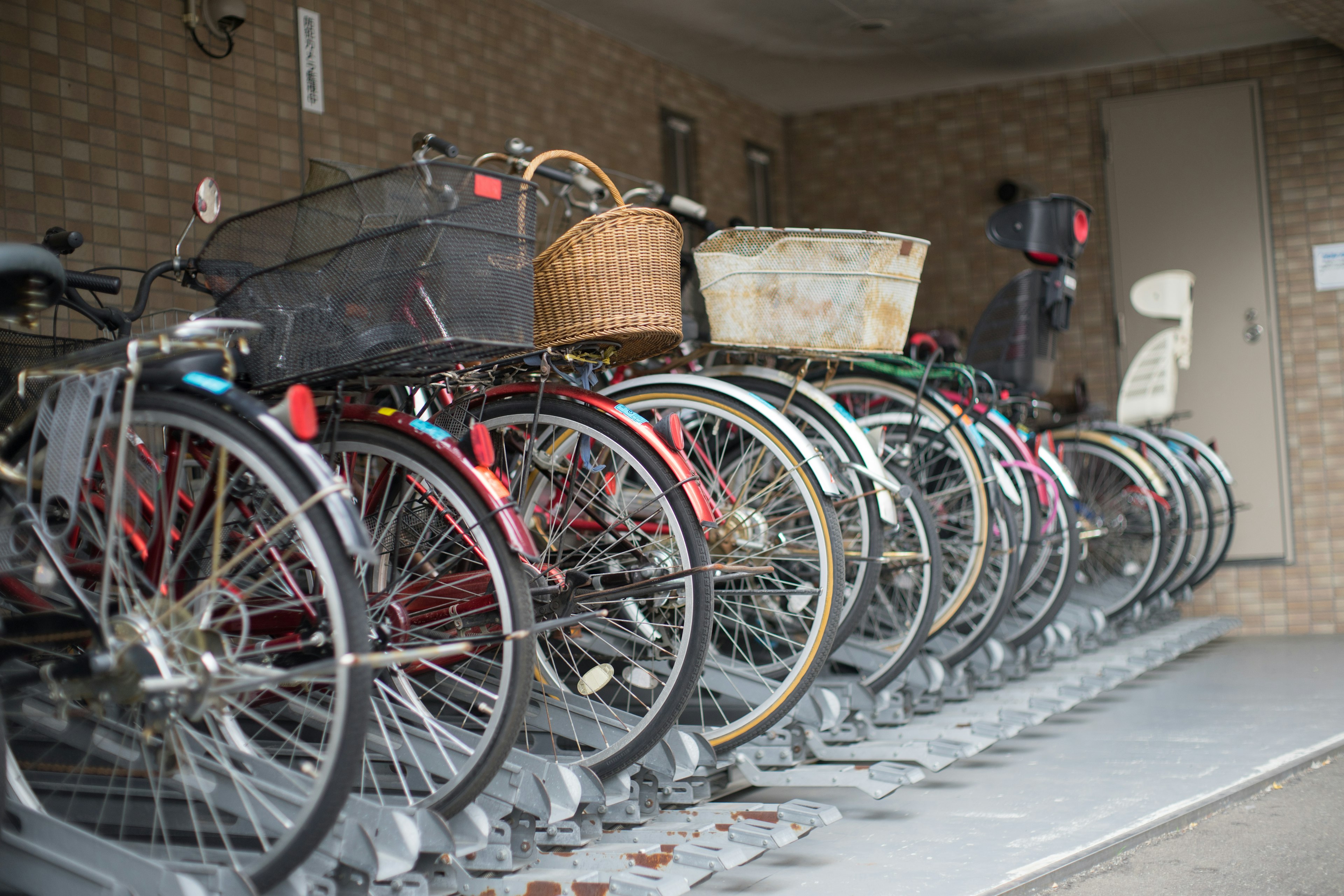 Interior of a bike storage area with parked bicycles and wheels