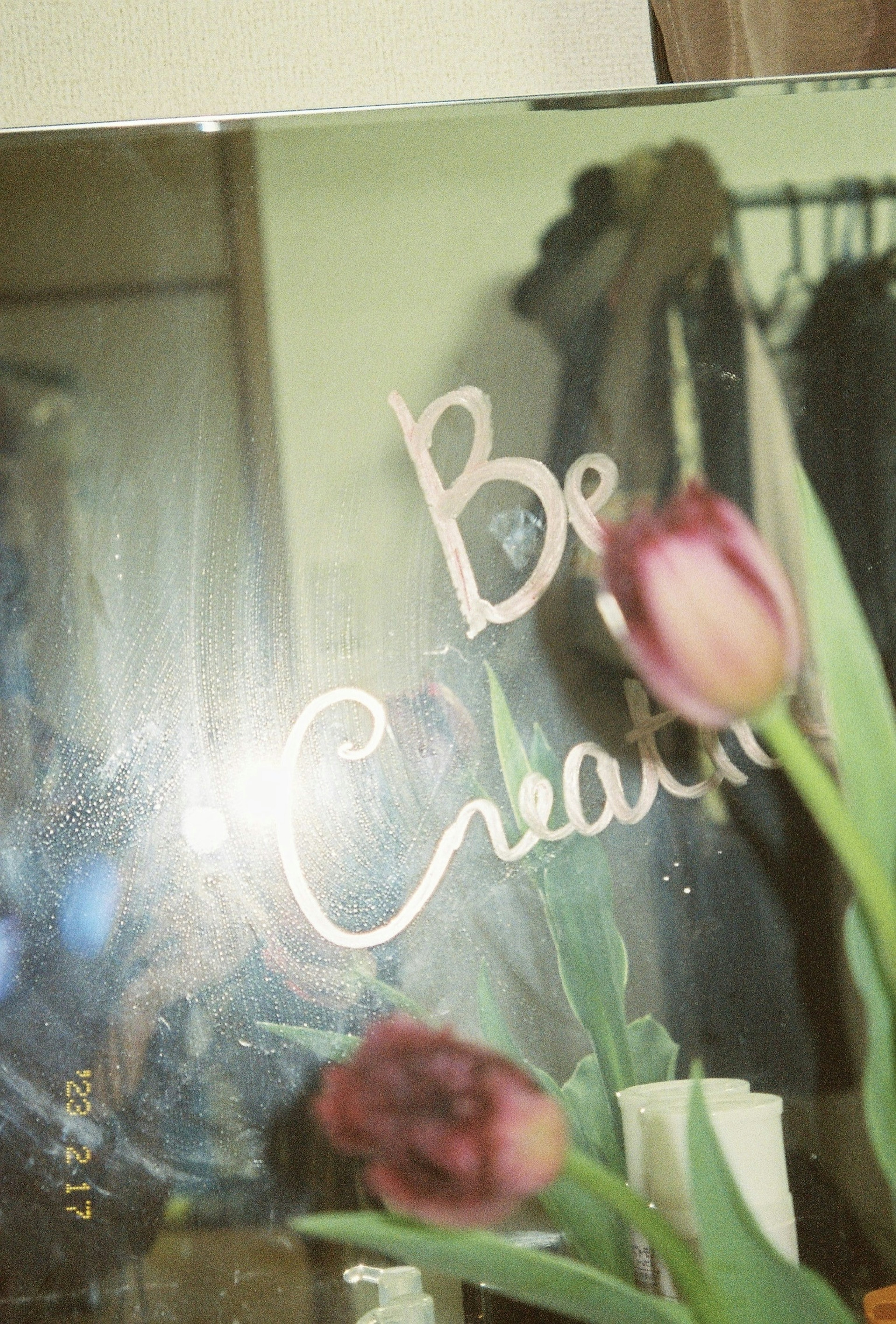 Image featuring the words Be Creative written on a mirror with tulips in the foreground