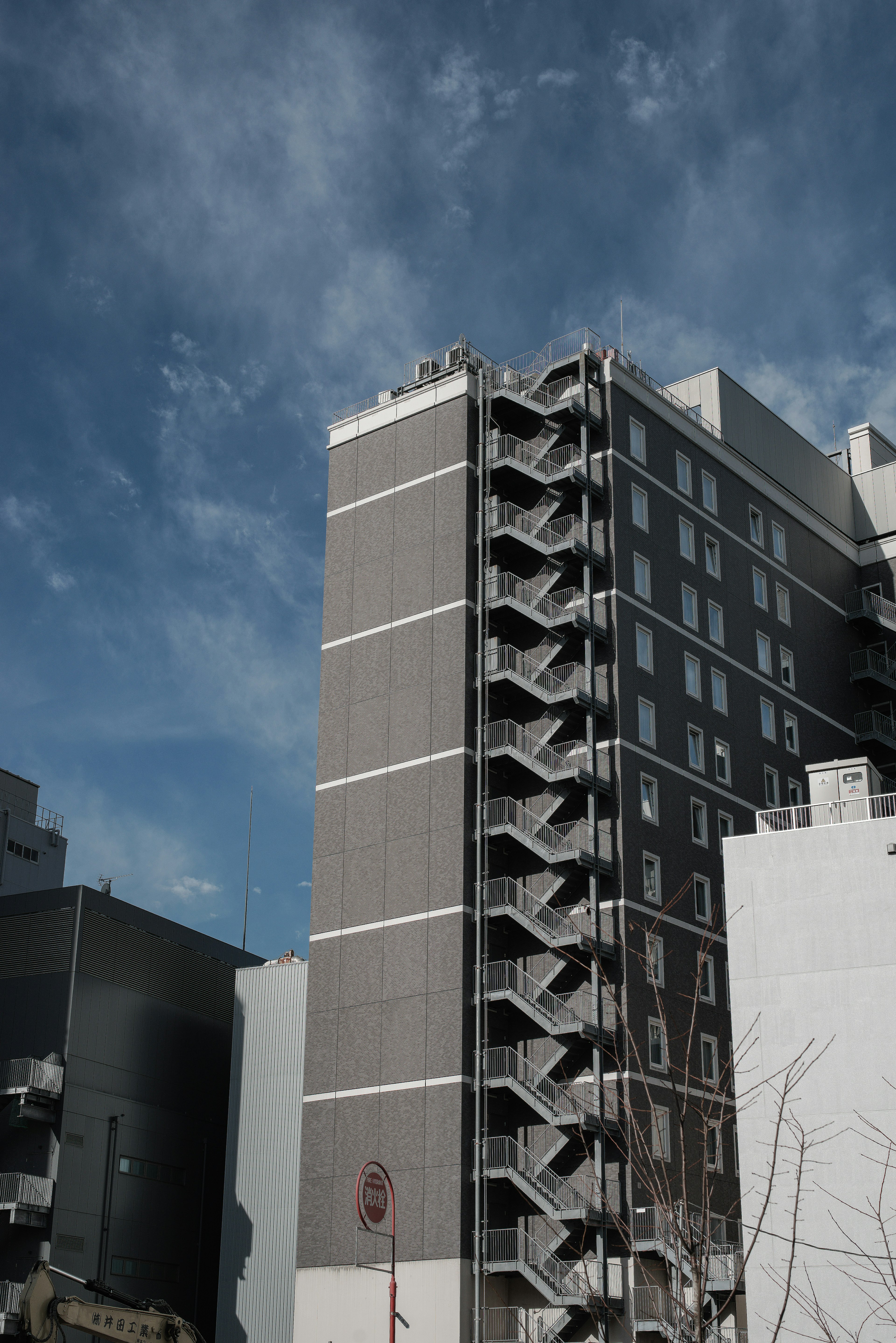 Urban landscape featuring a high-rise building with prominent staircases