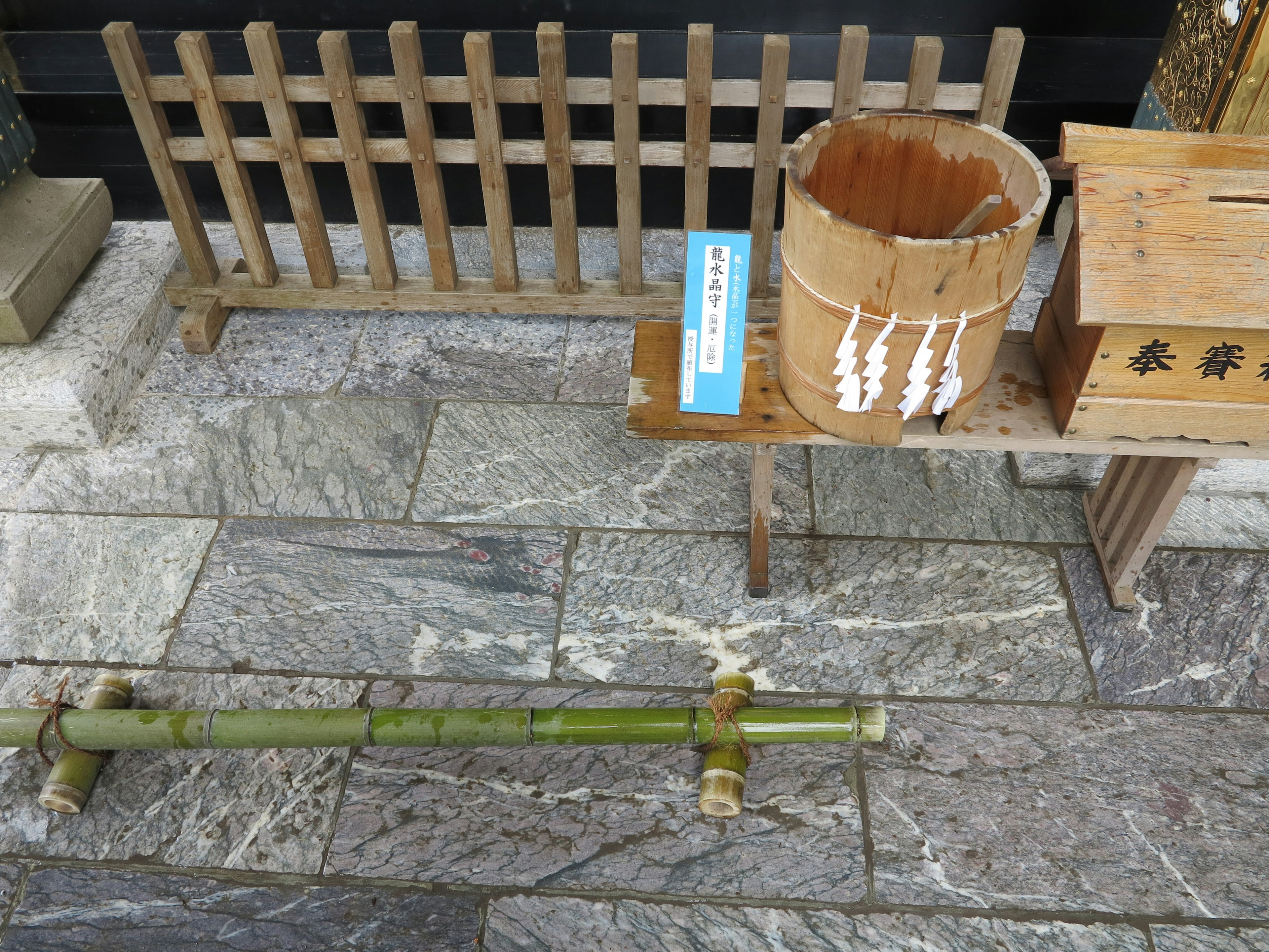 Traditional scene with a bamboo water basin and wooden boxes