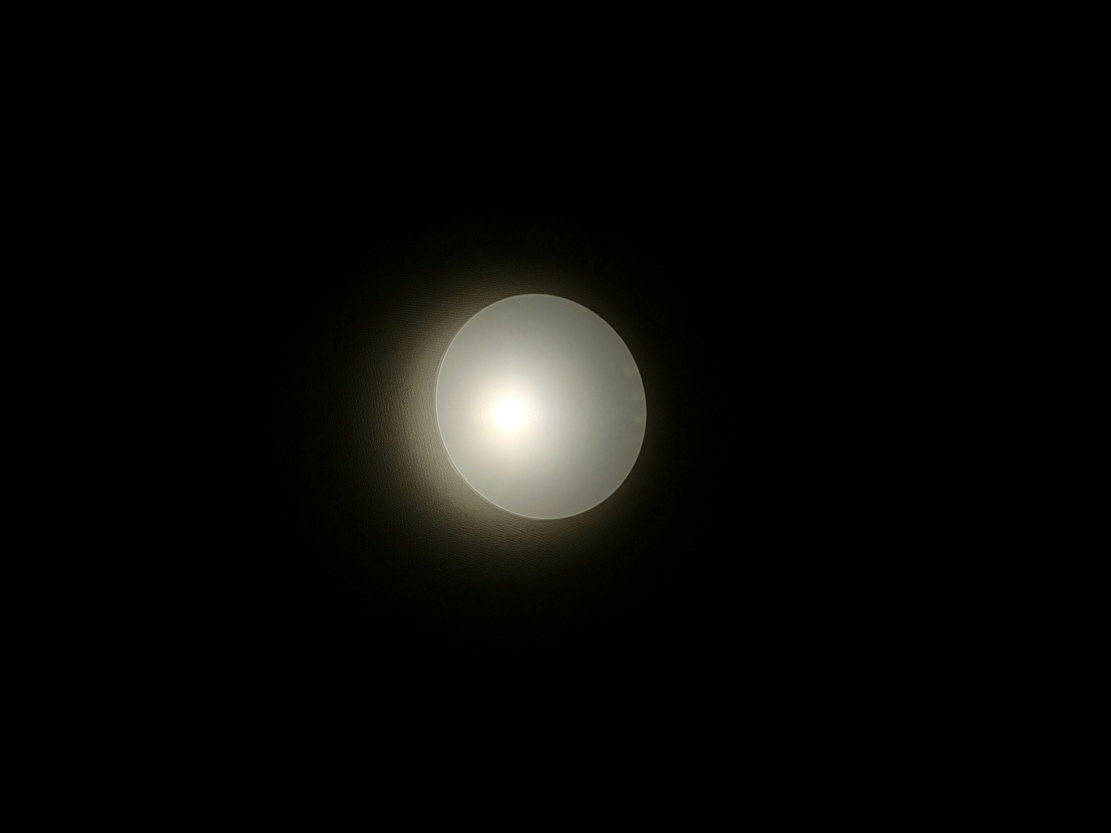 A glowing white sphere in darkness