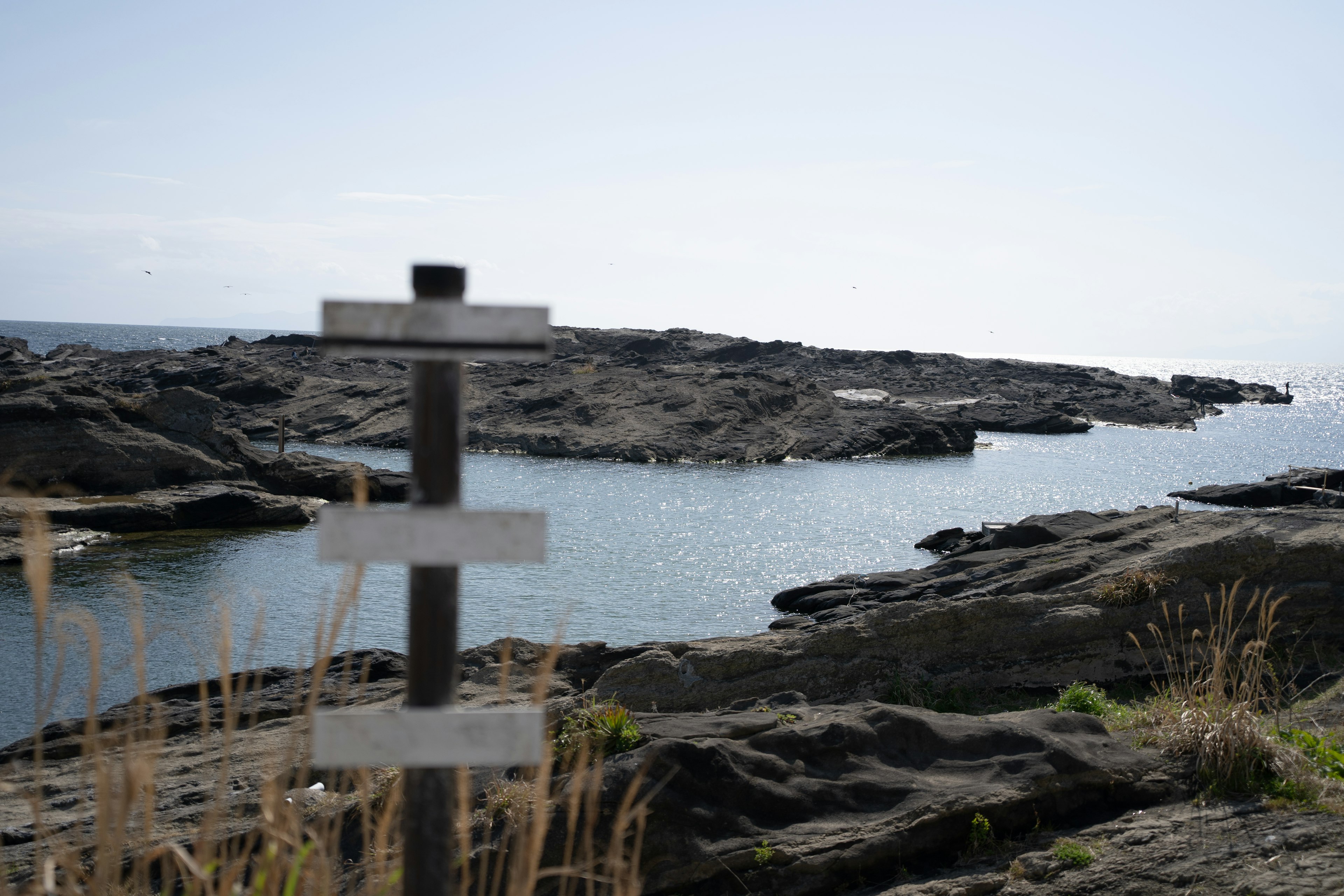 Coastal rocky landscape with a signpost