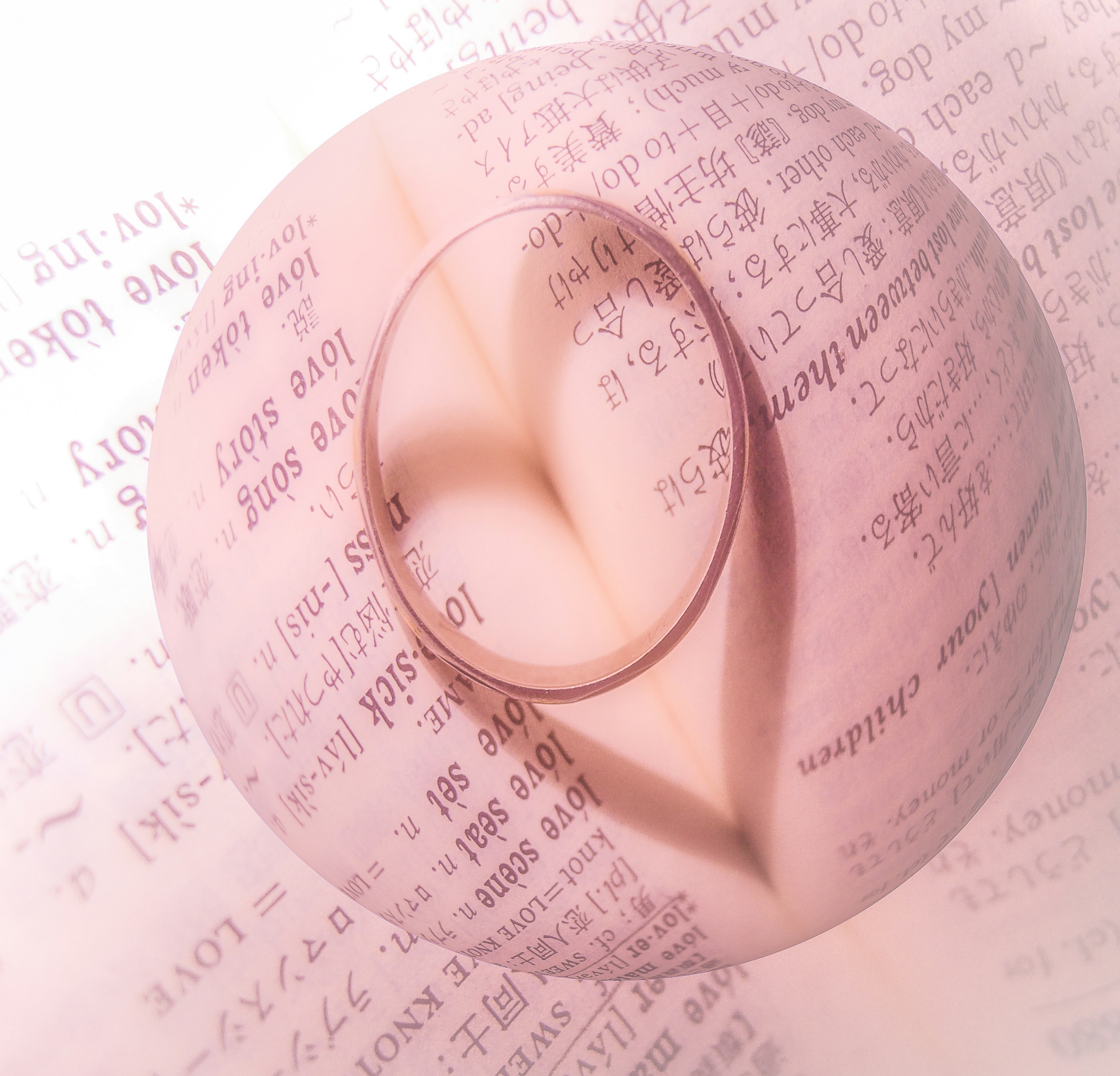 A pink circular object floating over text