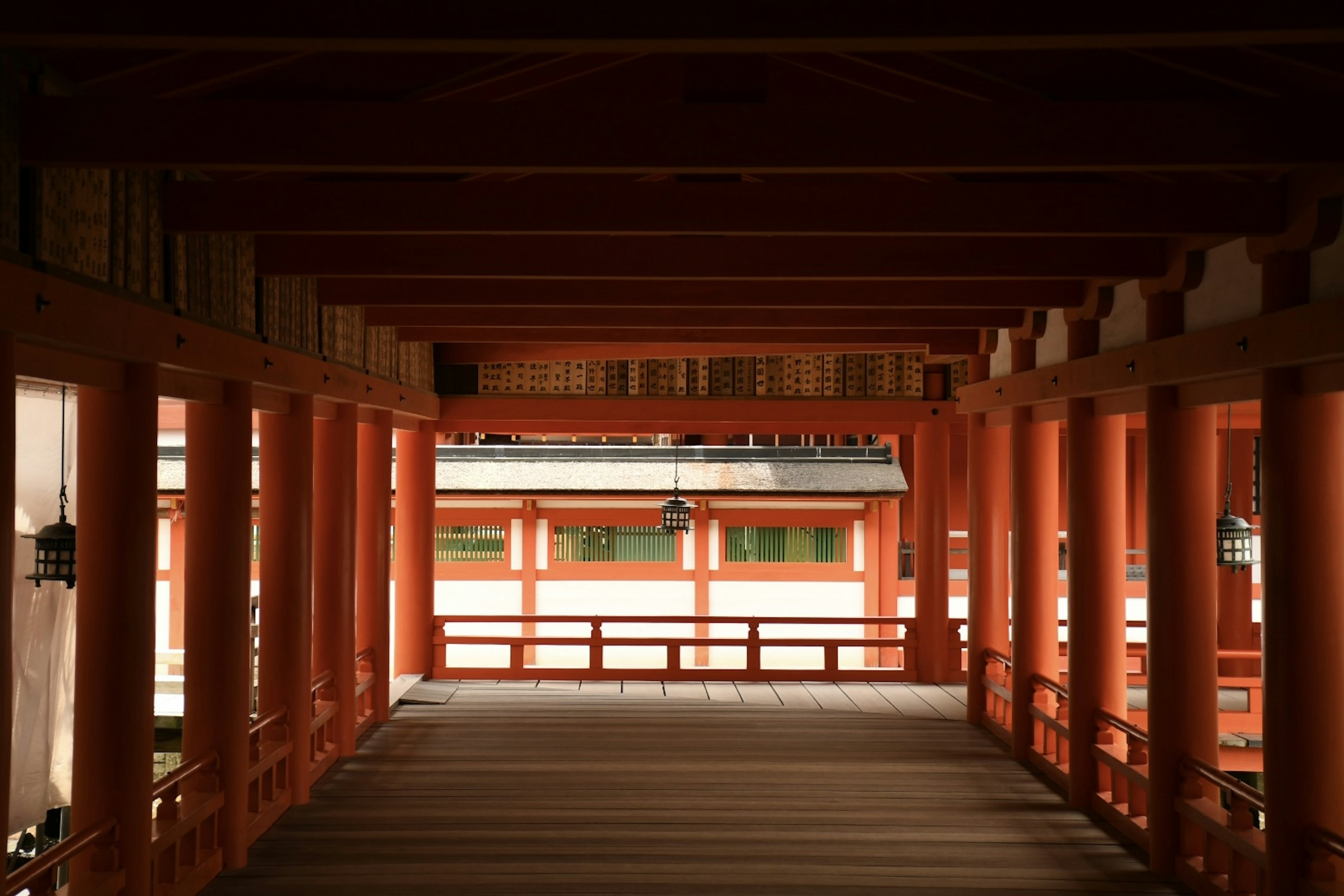 Interior of a shrine corridor featuring vibrant red pillars