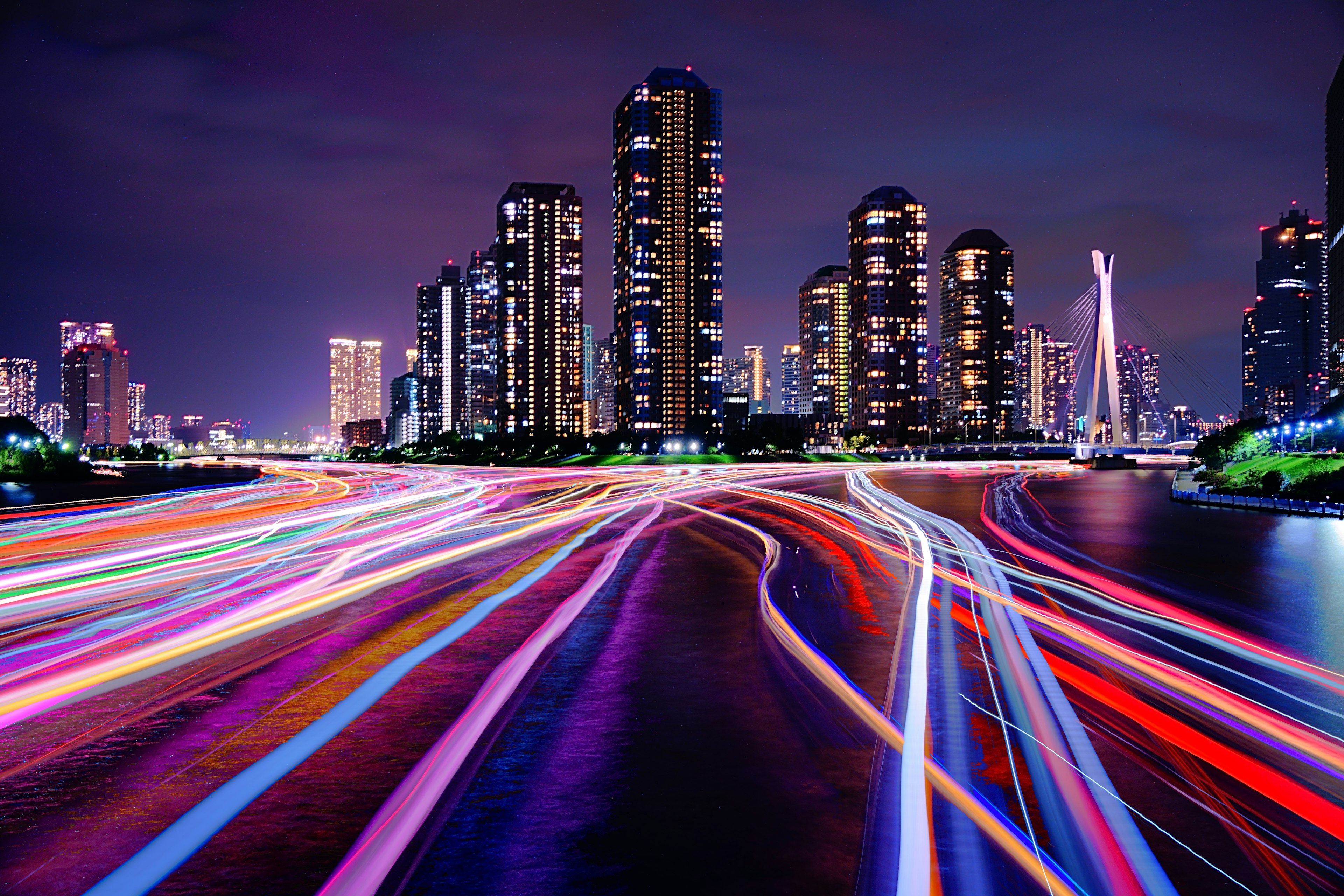 Night cityscape with flowing light trails and skyscrapers