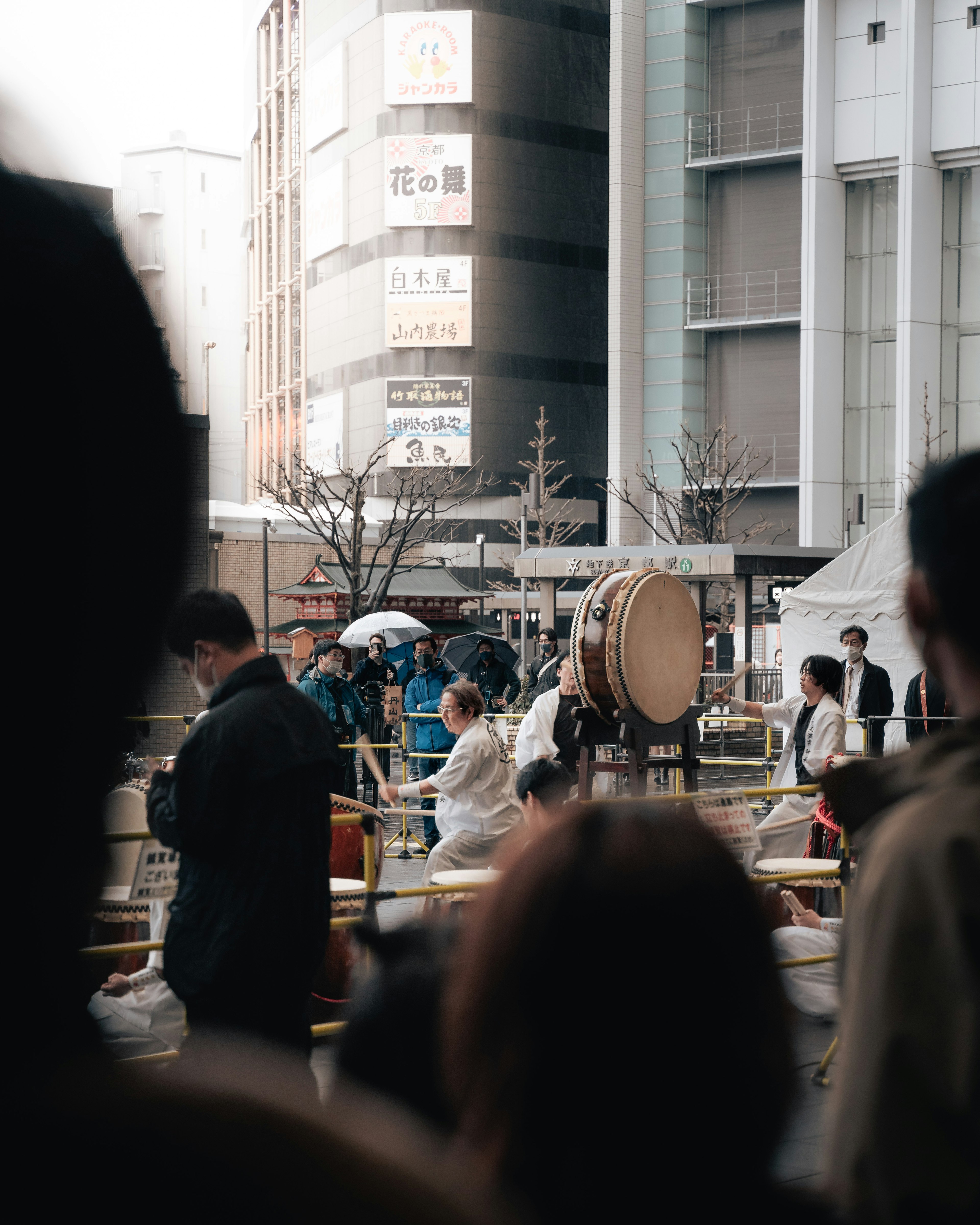 Crowd at a lively festival with a prominent drum