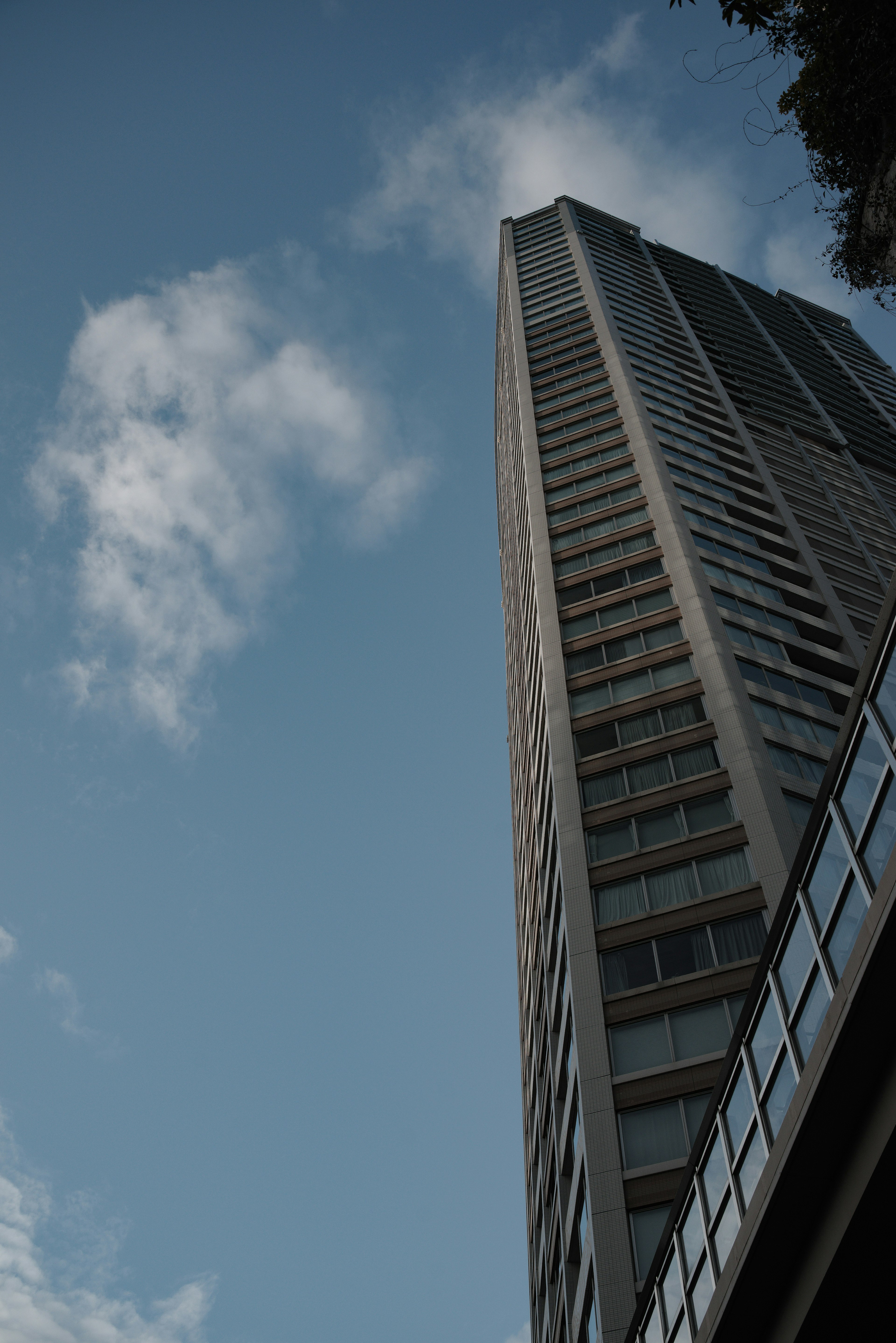 Image of a skyscraper viewed from below against a blue sky