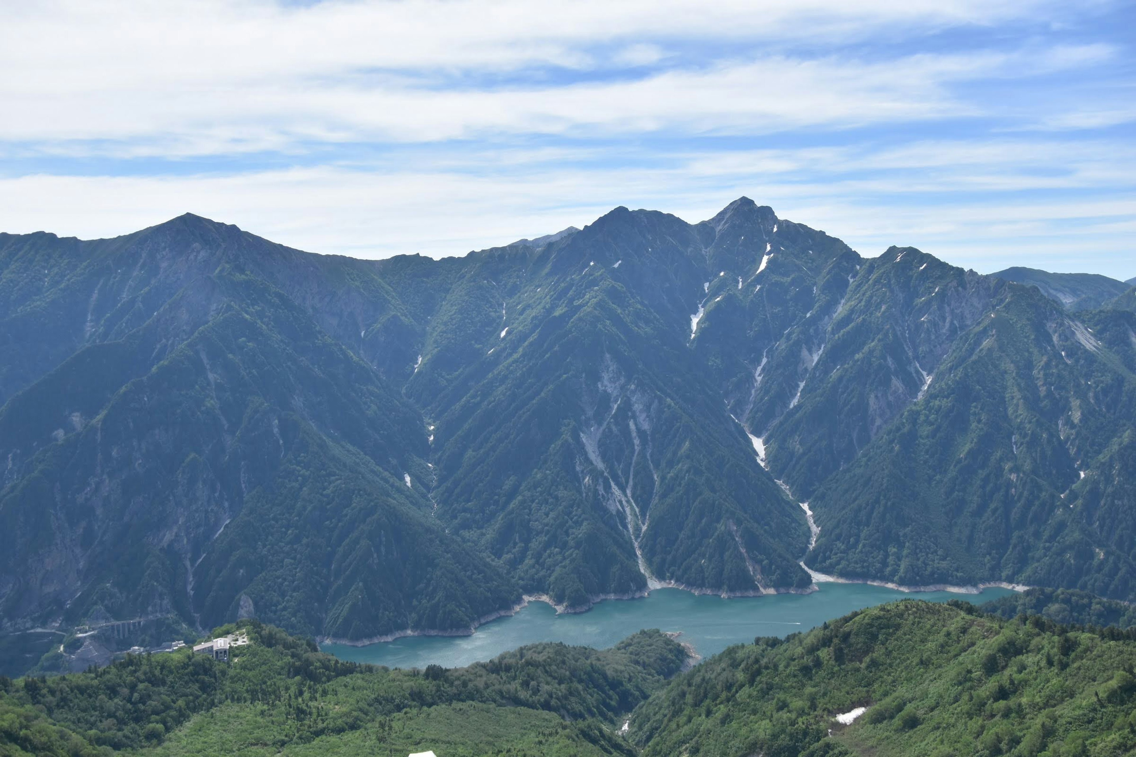 Scenic view of mountains and a lake under blue sky