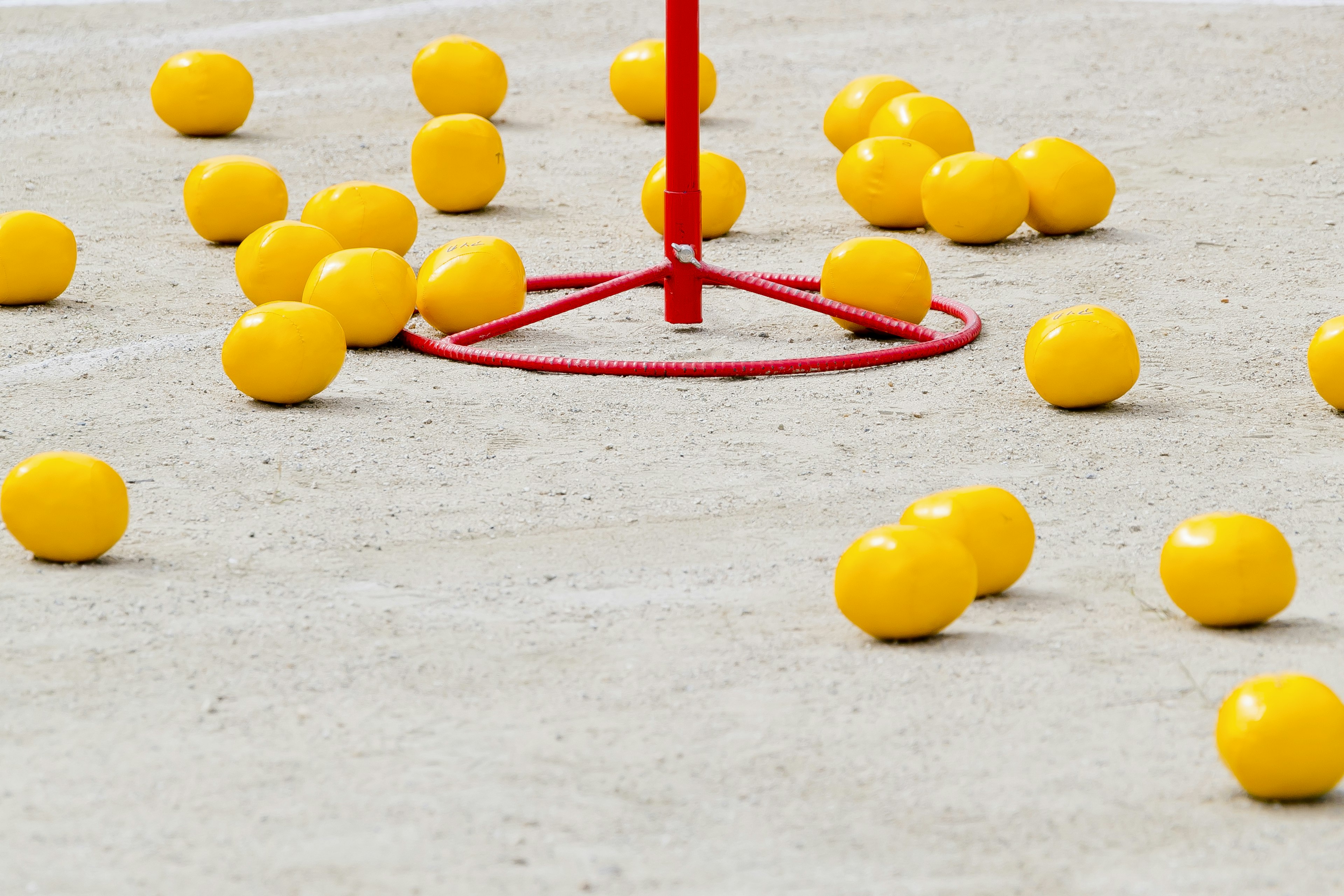 Yellow balls scattered around a red stand