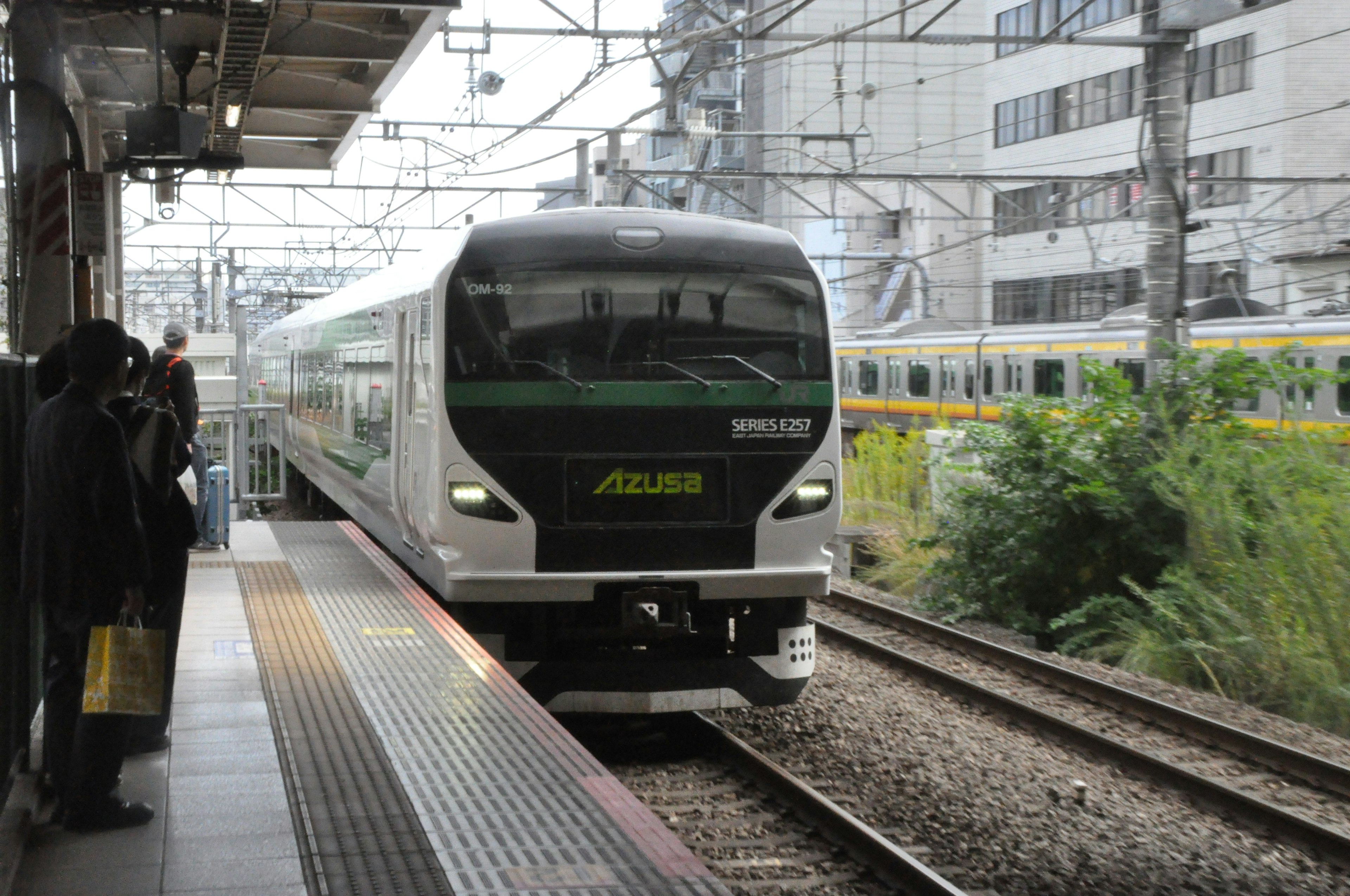 Modern train arriving at a station with urban background