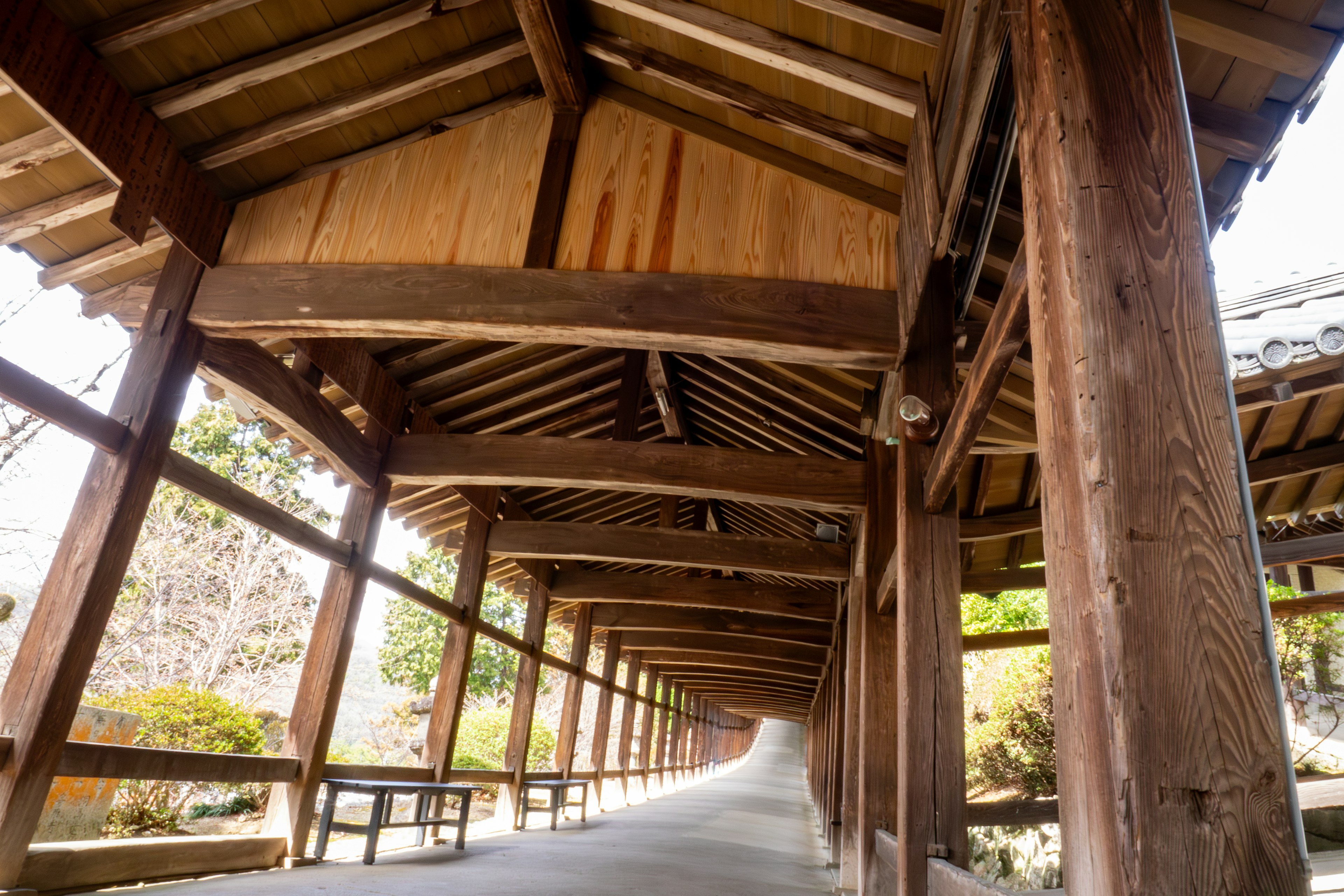 Interior view of a wooden arcade with beams and pillars