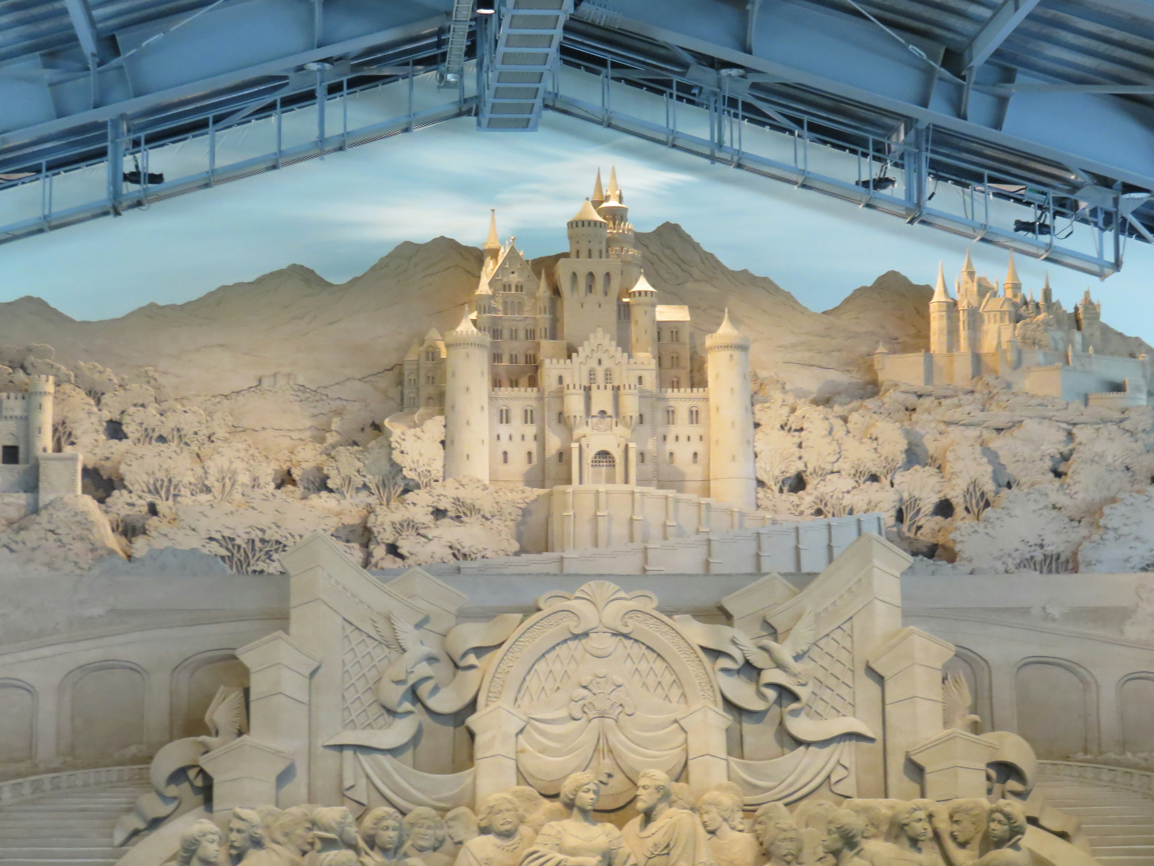 A stunning sand sculpture depicting a fantastical castle landscape