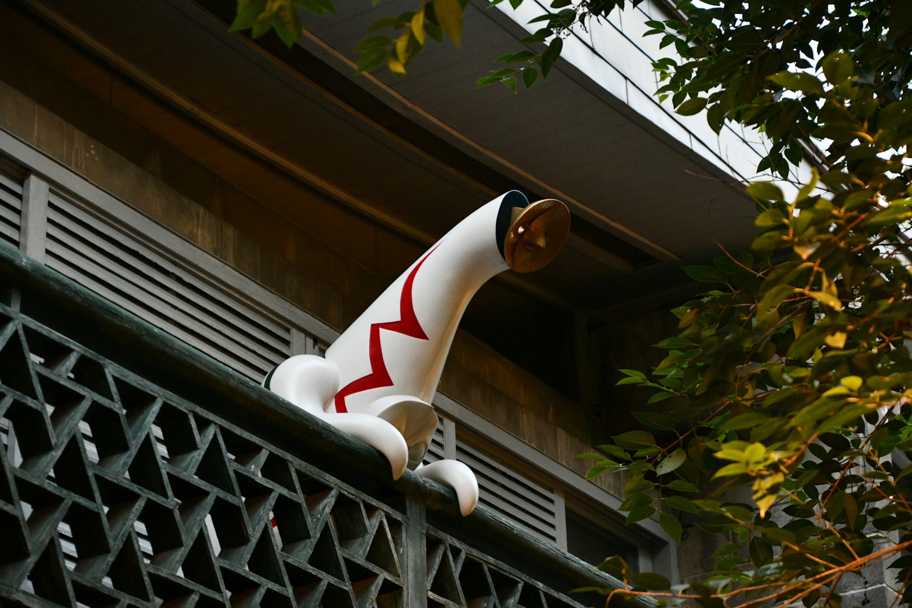 Decorative white object peeking through the trees