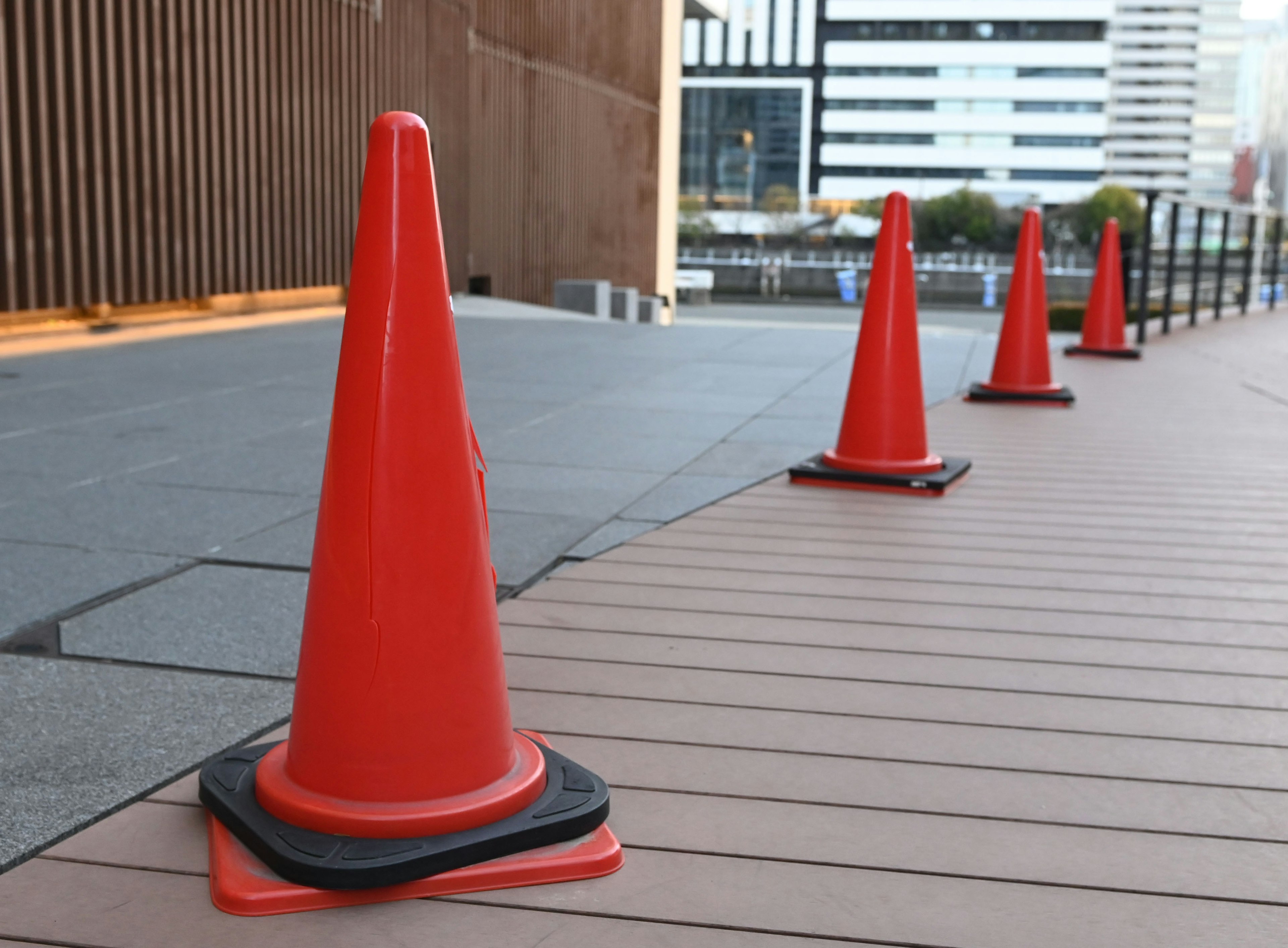 Image of red traffic cones lined up on a walkway