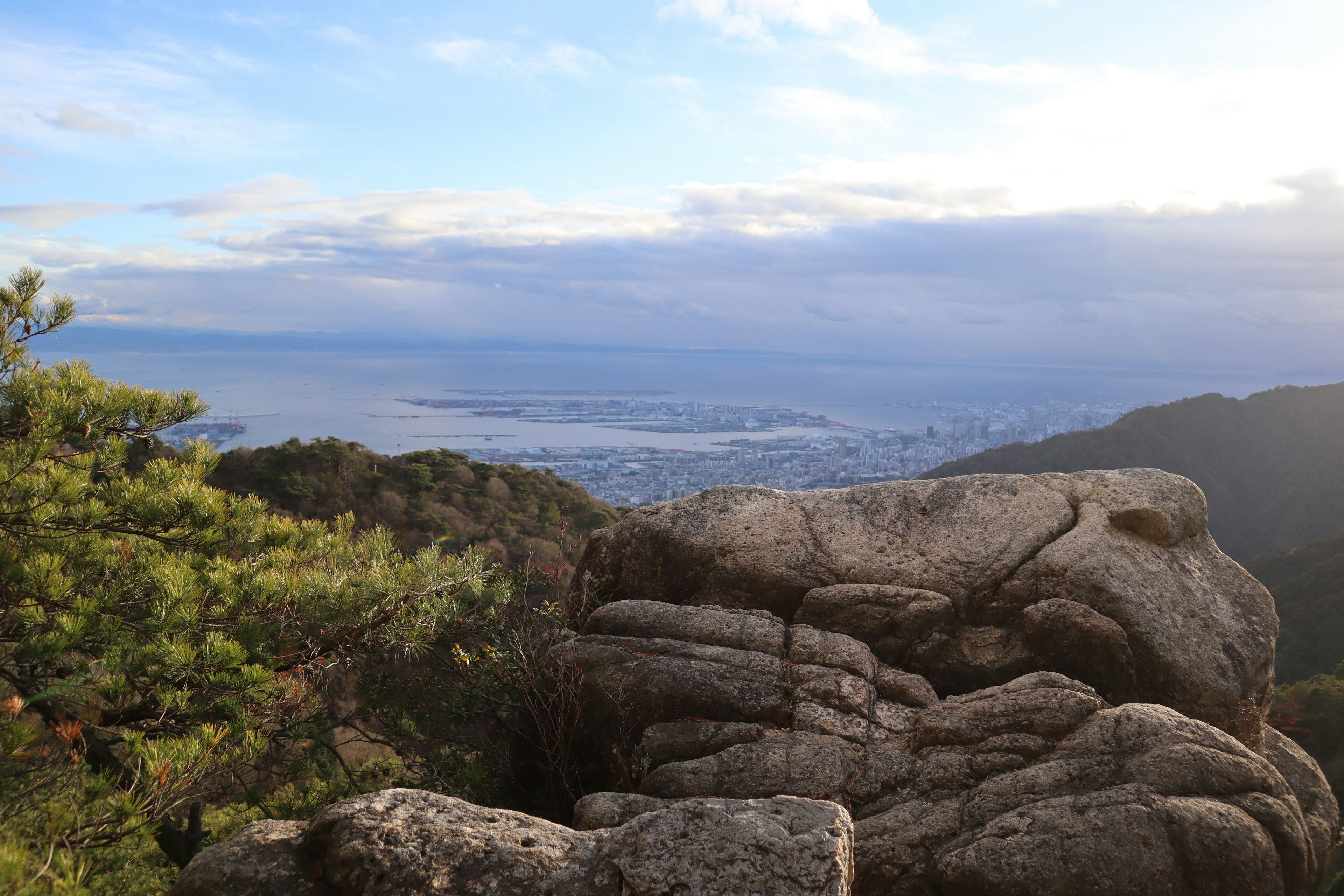 Vista escénica desde una montaña con grandes rocas y follaje verde