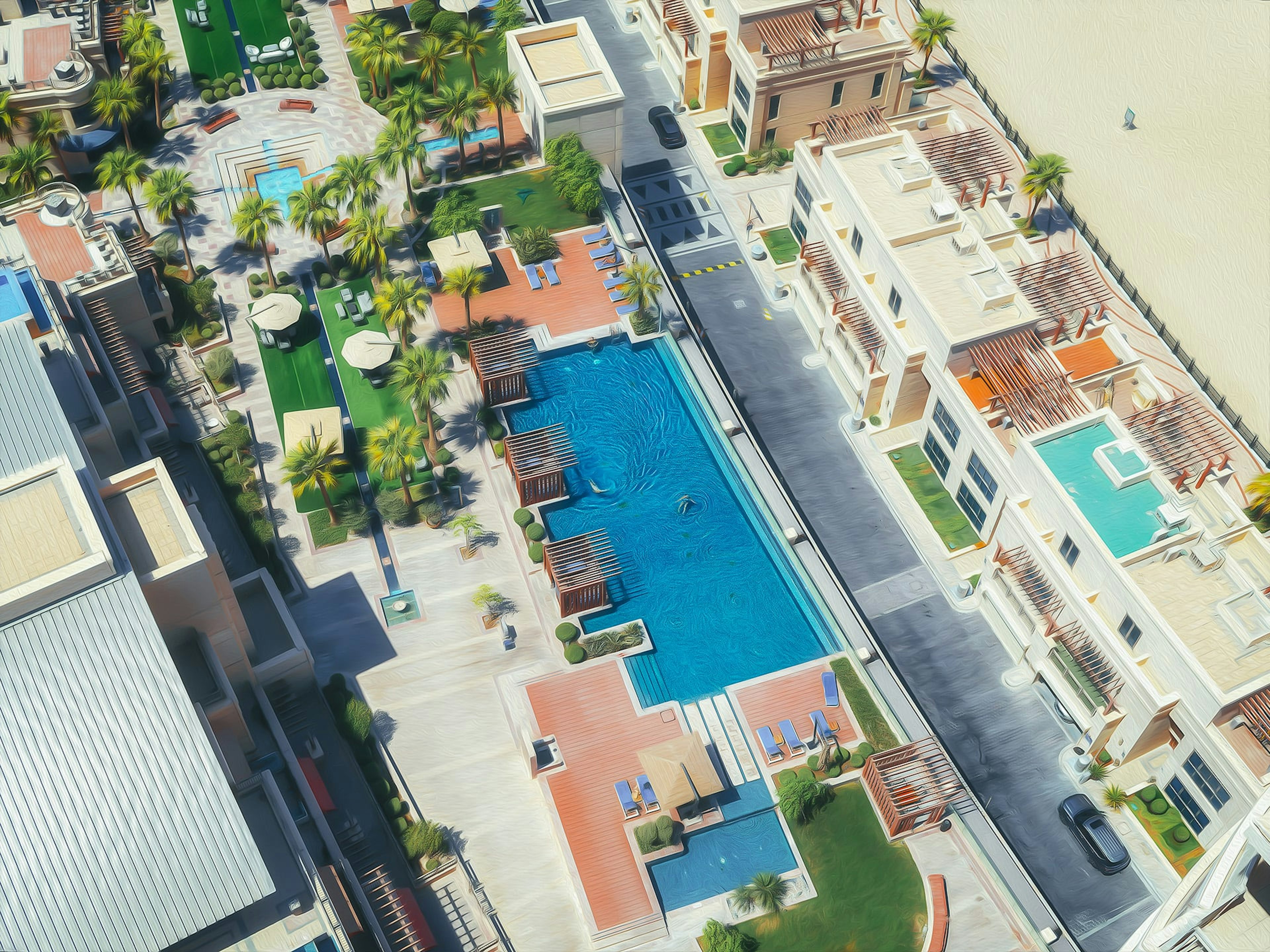 Vista aerea di un'area residenziale di lusso con piscina e giardini paesaggistici