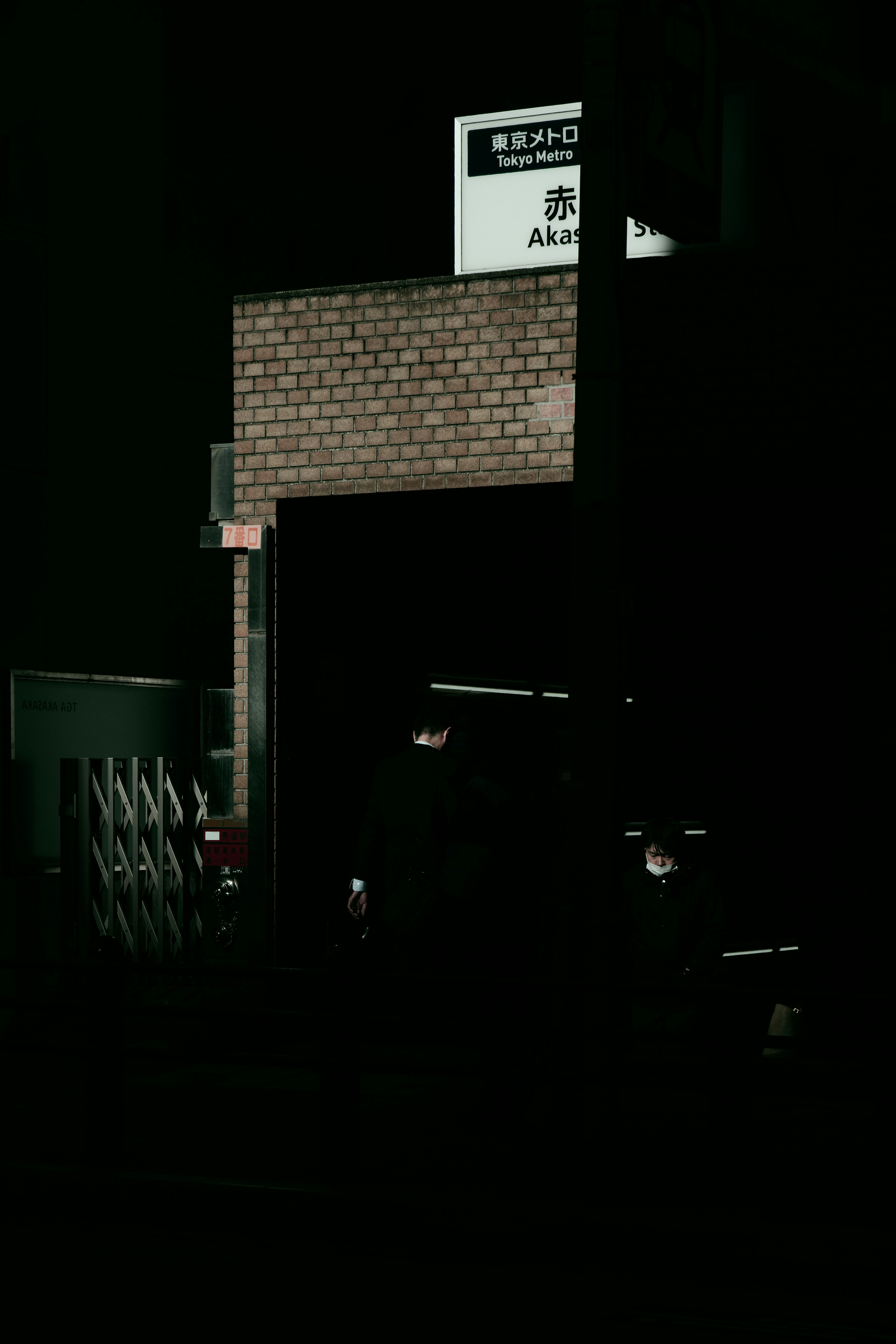 Brick wall and sign in a dark setting